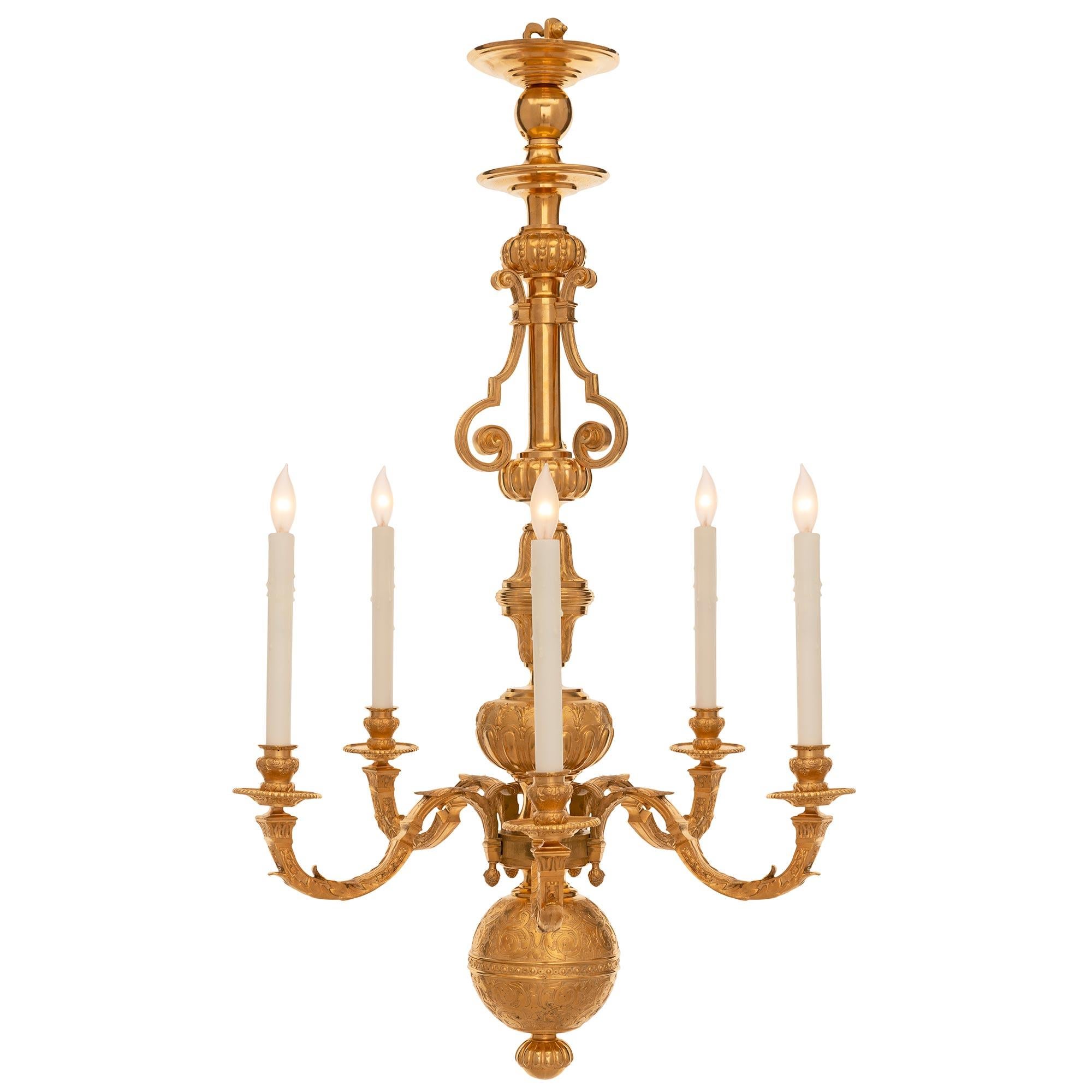 A wonderful and most decorative Dutch late 19th century Louis XVI st. ormolu chandelier. The five arm chandelier is centered by a fine bottom reeded finial and striking ball reserve with intricately detailed etched scrolled foliate designs with a