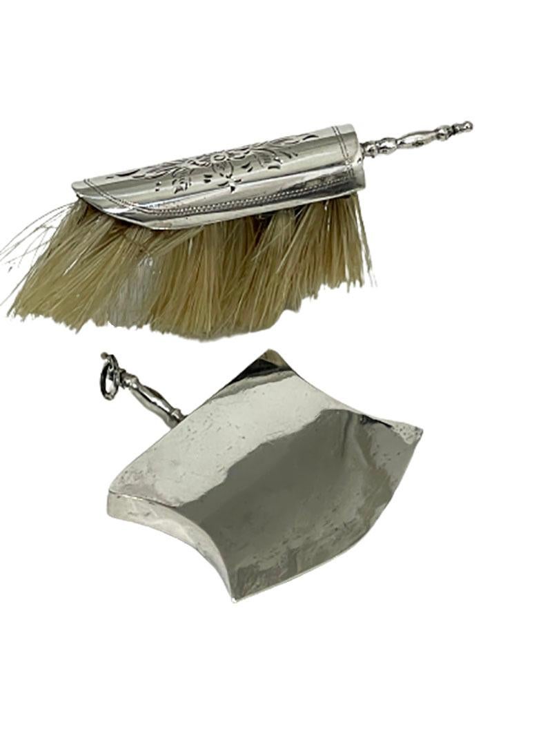 A Dutch silver miniature sweeper and dustpan by Anne Venema, Sneek

A Dutch silver miniature sweeper and dustpan, both engraved. The dust pan has an eyelet. Marked with the Dutch silver Hallmark 