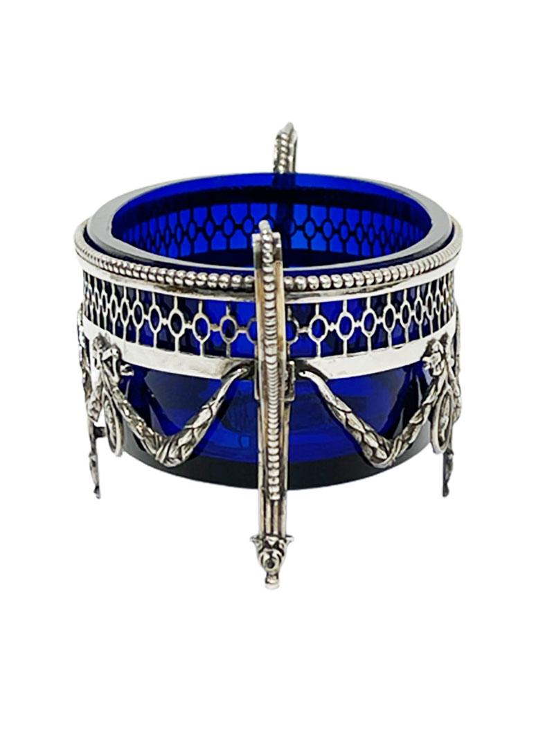 A Dutch silver oval jardiniere in Louis XVI style with cobalt blue glass, 1913

A Dutch silver oval jardiniere in Louis XVI style with cobalt blue glass inner tray. The jardiniere is openwork cut 
by hand and decorated with portrait medallions
