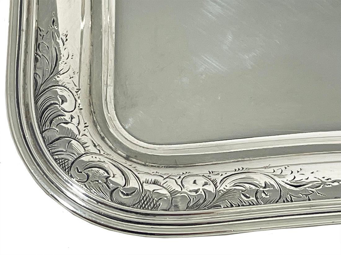 A Dutch Silver Salver by George Reevers, 1856

A silver rectangular salver with round shapes, made by the silversmith George Reevers, Amsterdam, dated with the year letter W for 1856. The salver has a double edge with an engraving of Rocaille leaf