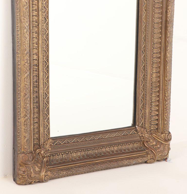 A Dutch style brass repouse mirror circa 1880. Top crest is removeable In Good Condition For Sale In Philadelphia, PA