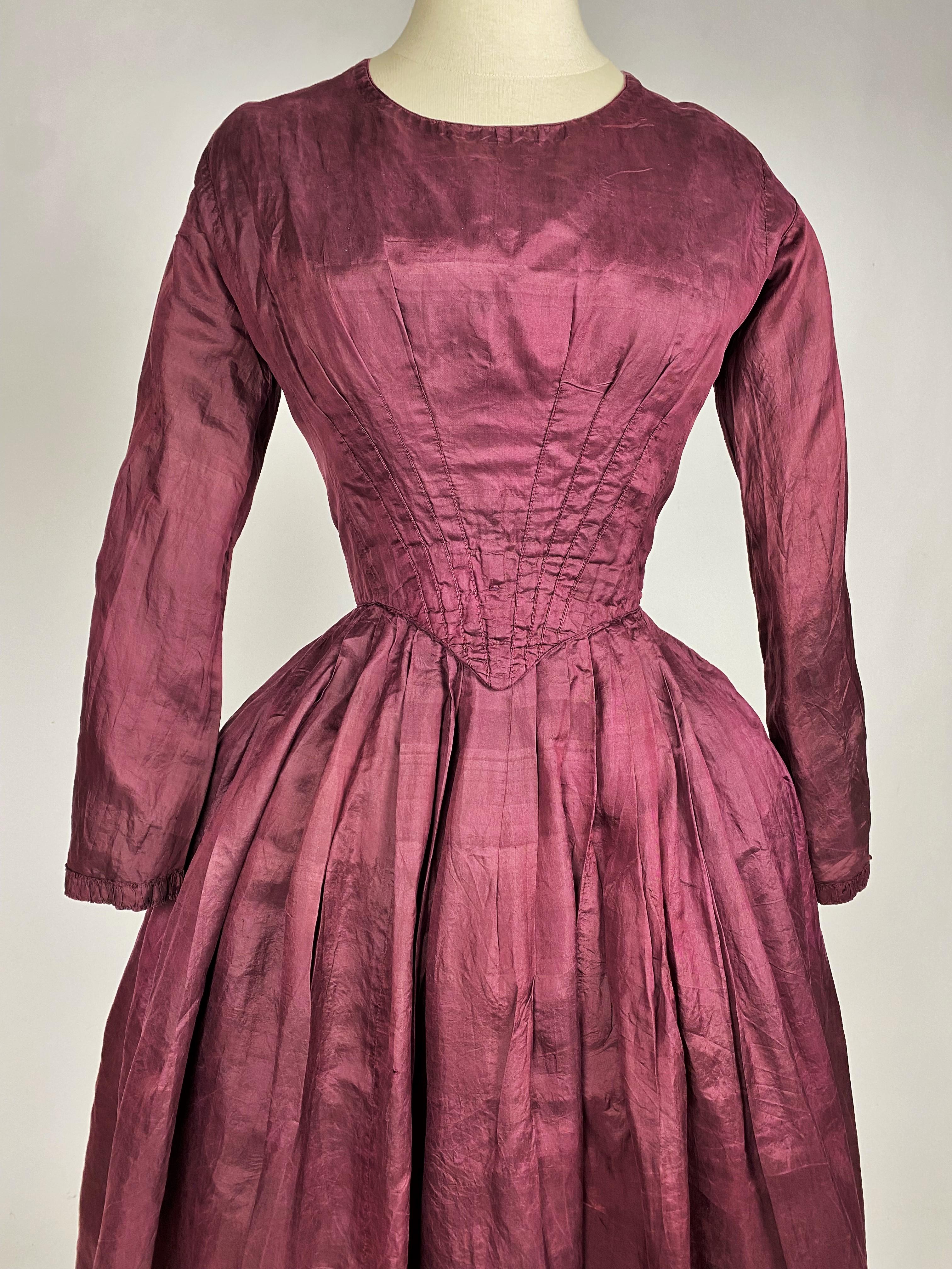 Circa 1845-1850
France
Day dress in wine coloured silk pongee taffeta, aubergine dating from the late Romantic period. This dress has been washed and dyed bordeau probably for a second life. Elegant bourgeois dress with a bodice fitted at the neck