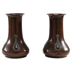 A E Jones. A pair of hand-hammered copper vases with silver teardrop decoration