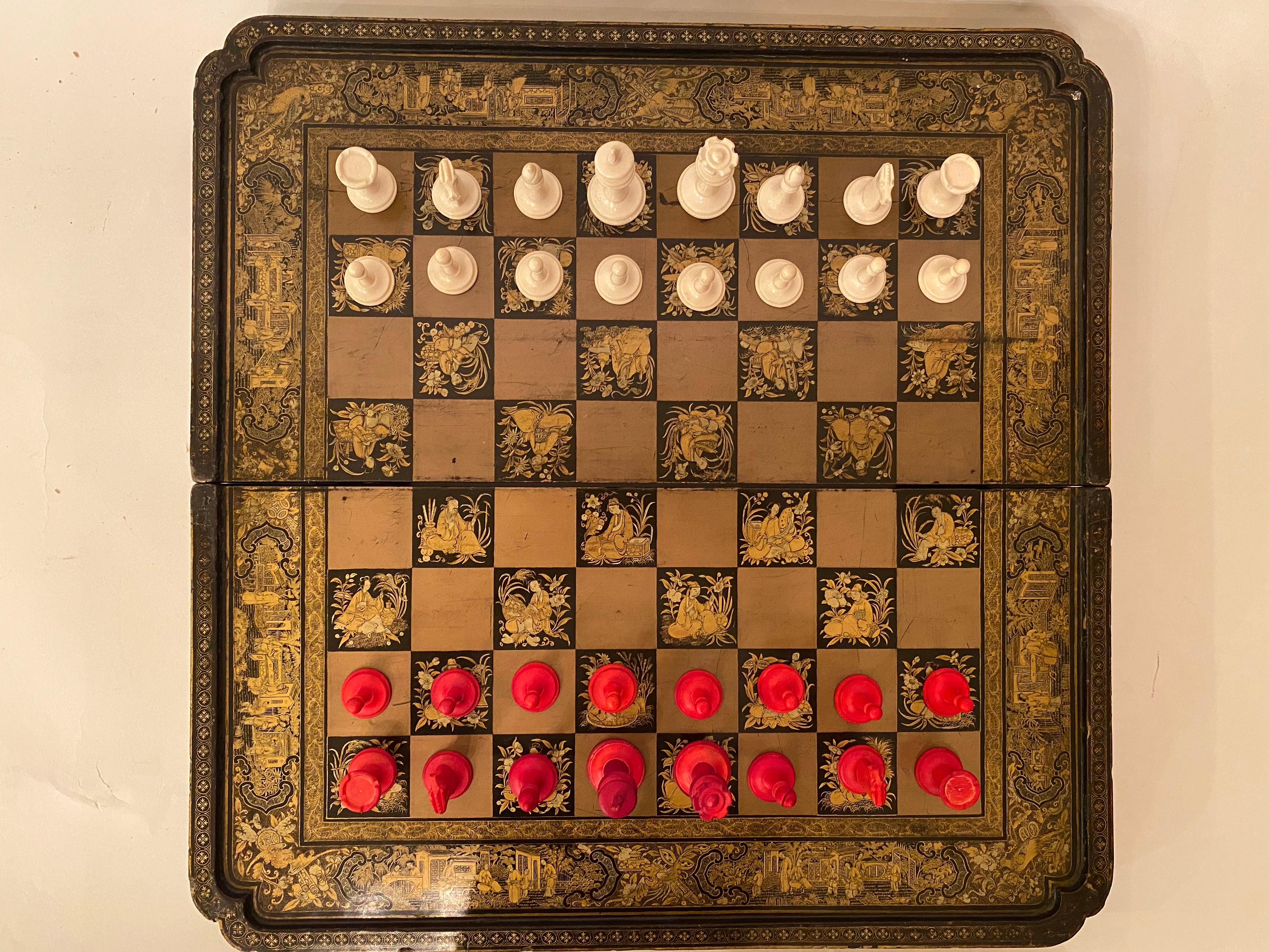 A early 19th century Chinese export lacquer chess and backgammon board 50 cm x 50 cm, the squares with daoist immortals gold black lacquer board, 16 white chesses, 16 red chesses.