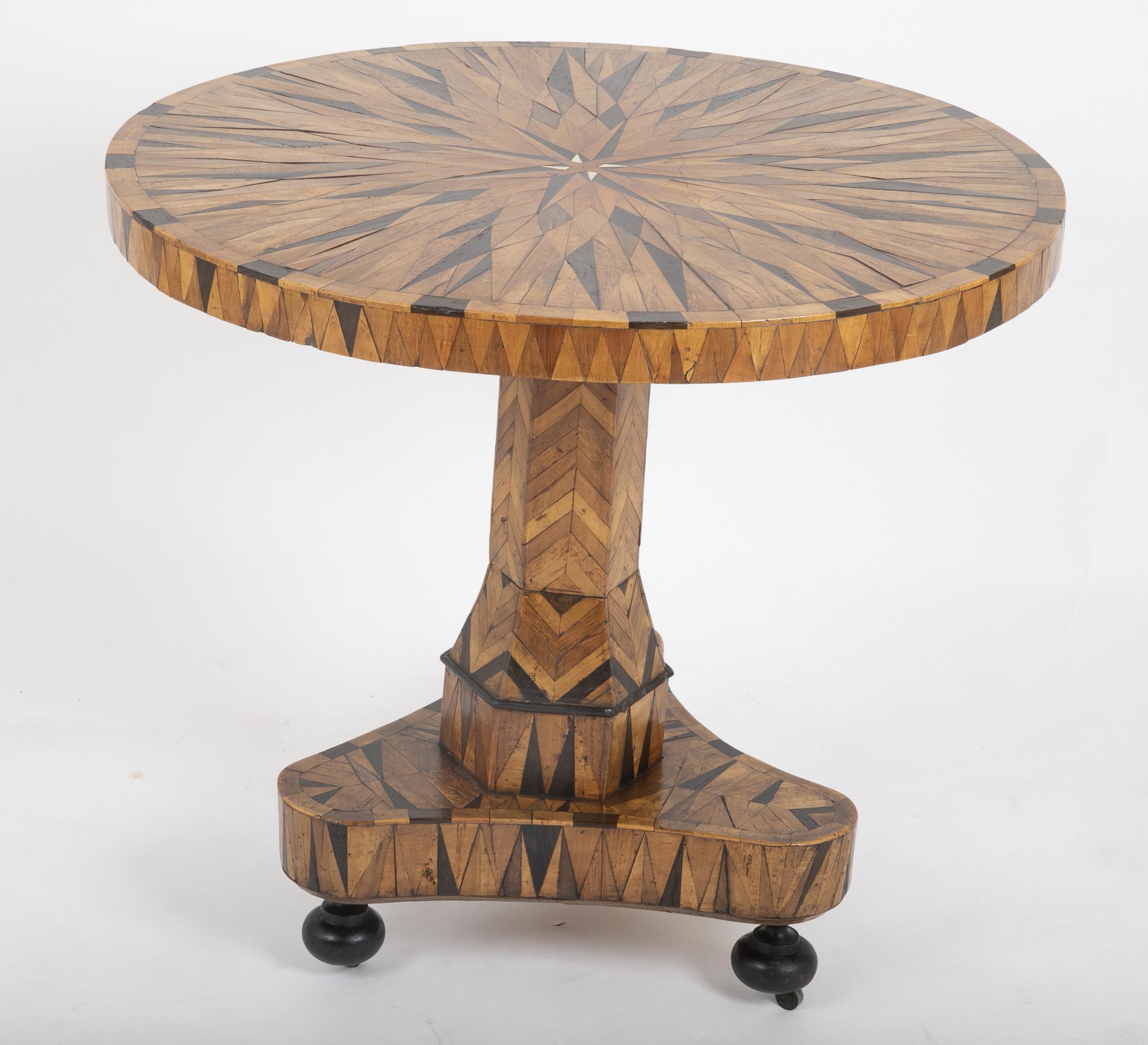 A beautifully patinated parquetry table consisting of oak, rosewood and Wenge. Continental, first quarter of the 19th century.
