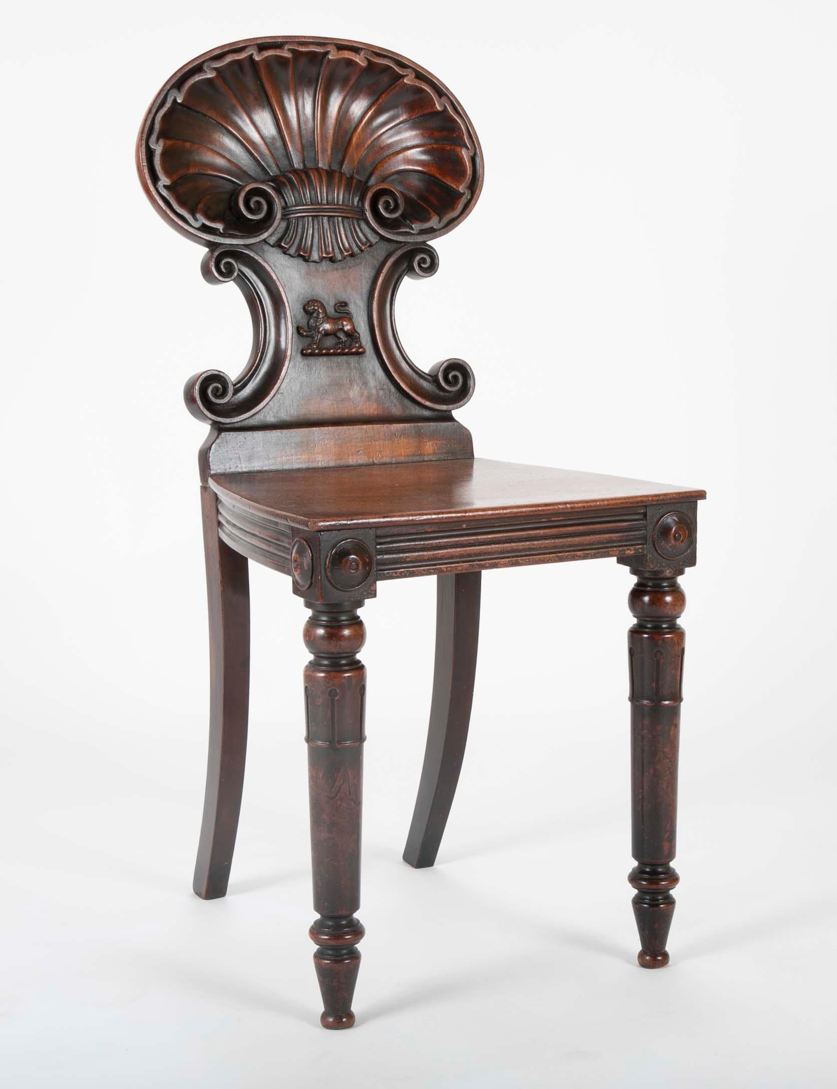 A Georgian shell back hall chair with lion carving and great patina. English, circa 1810.
 