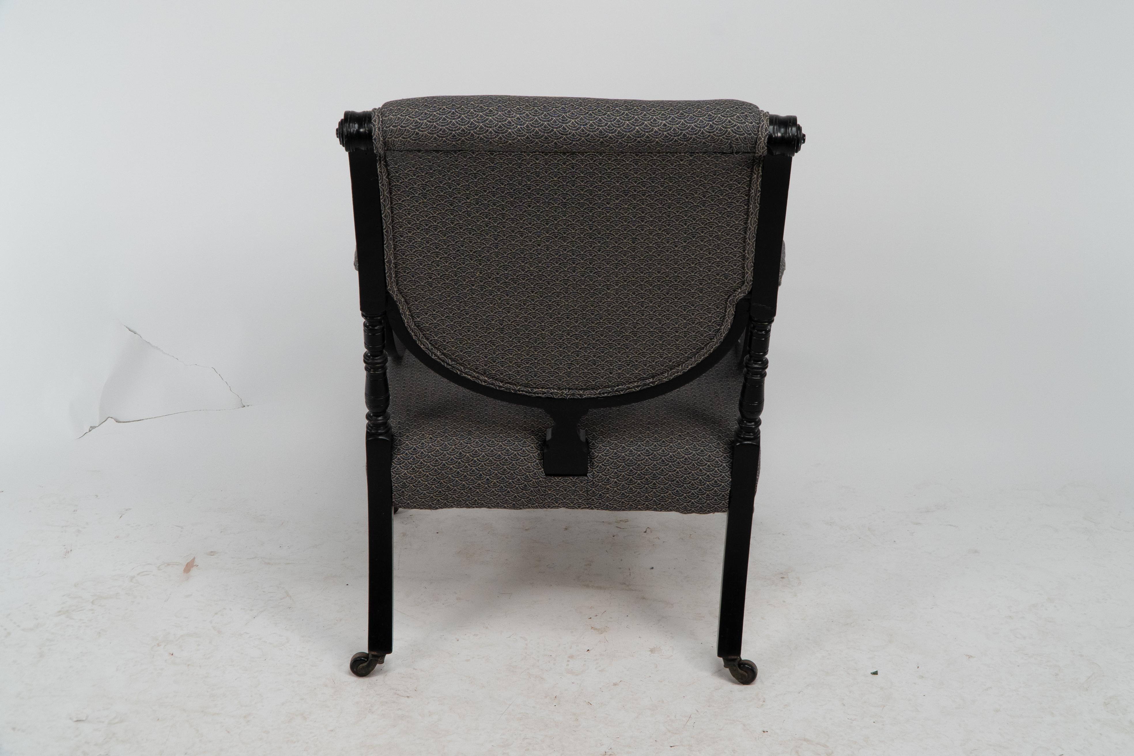 An Aesthetic Movement ebonized & upholstered armchair with sweeping side rails. For Sale 12