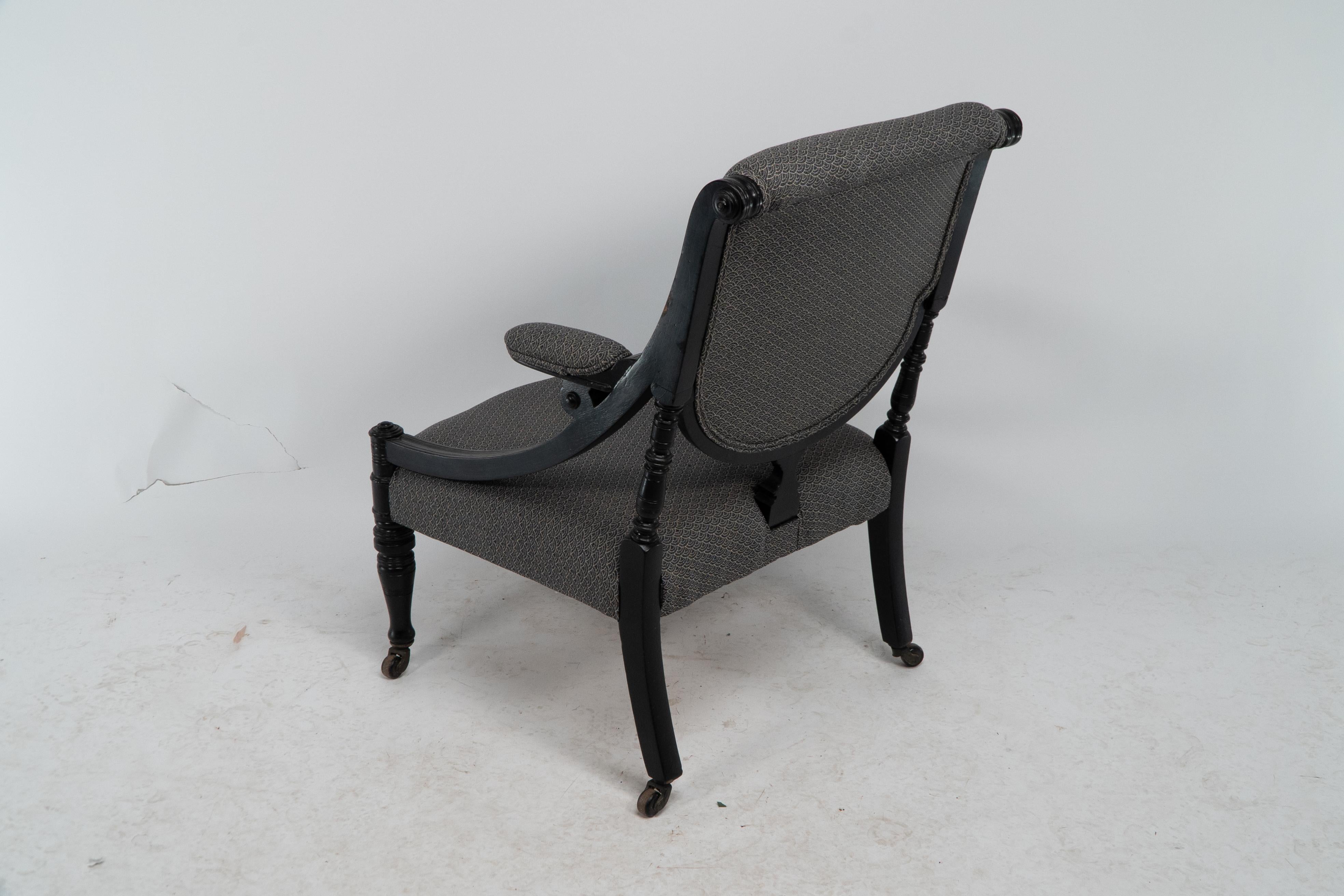 An Aesthetic Movement ebonized & upholstered armchair with sweeping side rails. For Sale 11