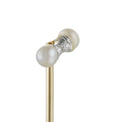 A Edwardian diamond and pearl stick pin