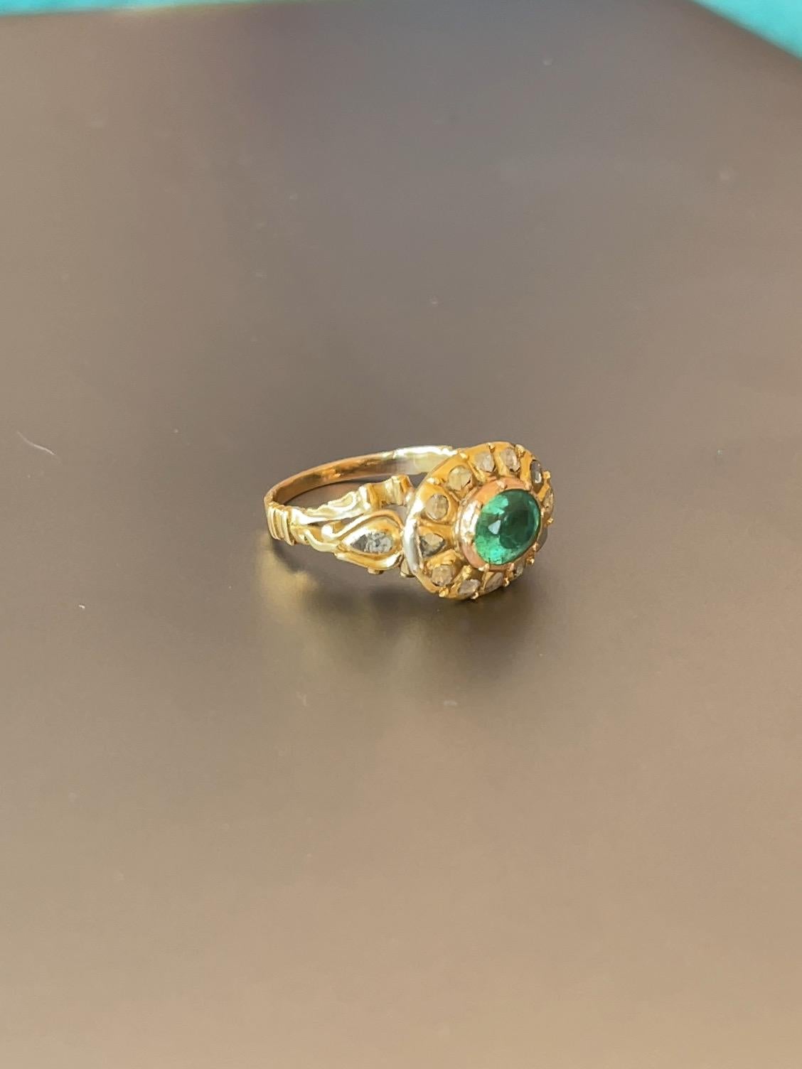 A Magnificent Portuguese cocktail ring, from the XVIII Century (1700s) a guaranteed head turner. 

This Magnificent ring is composed of Portuguese 19.2 Karat Gold, it has a centra Oval Colombian emerald with 0.80 Carats, that was carved to the ring