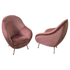 An elegant pair of easy chairs with brass legs, italian mid-century.
