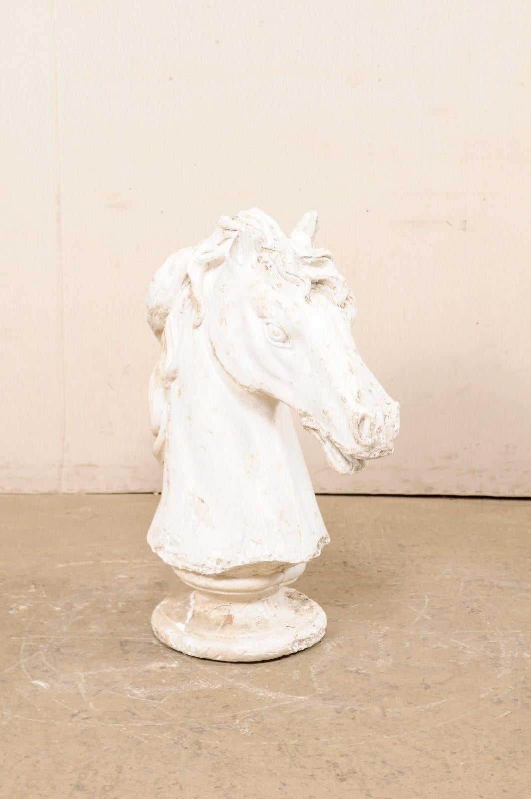 A European plaster sculptural horse head bust, from the 20th century. This fabulous plaster art piece from Europe, standing just shy of 3 feet in height, features a three-dimensional horse head with a round pedestal base. The forward-facing horse