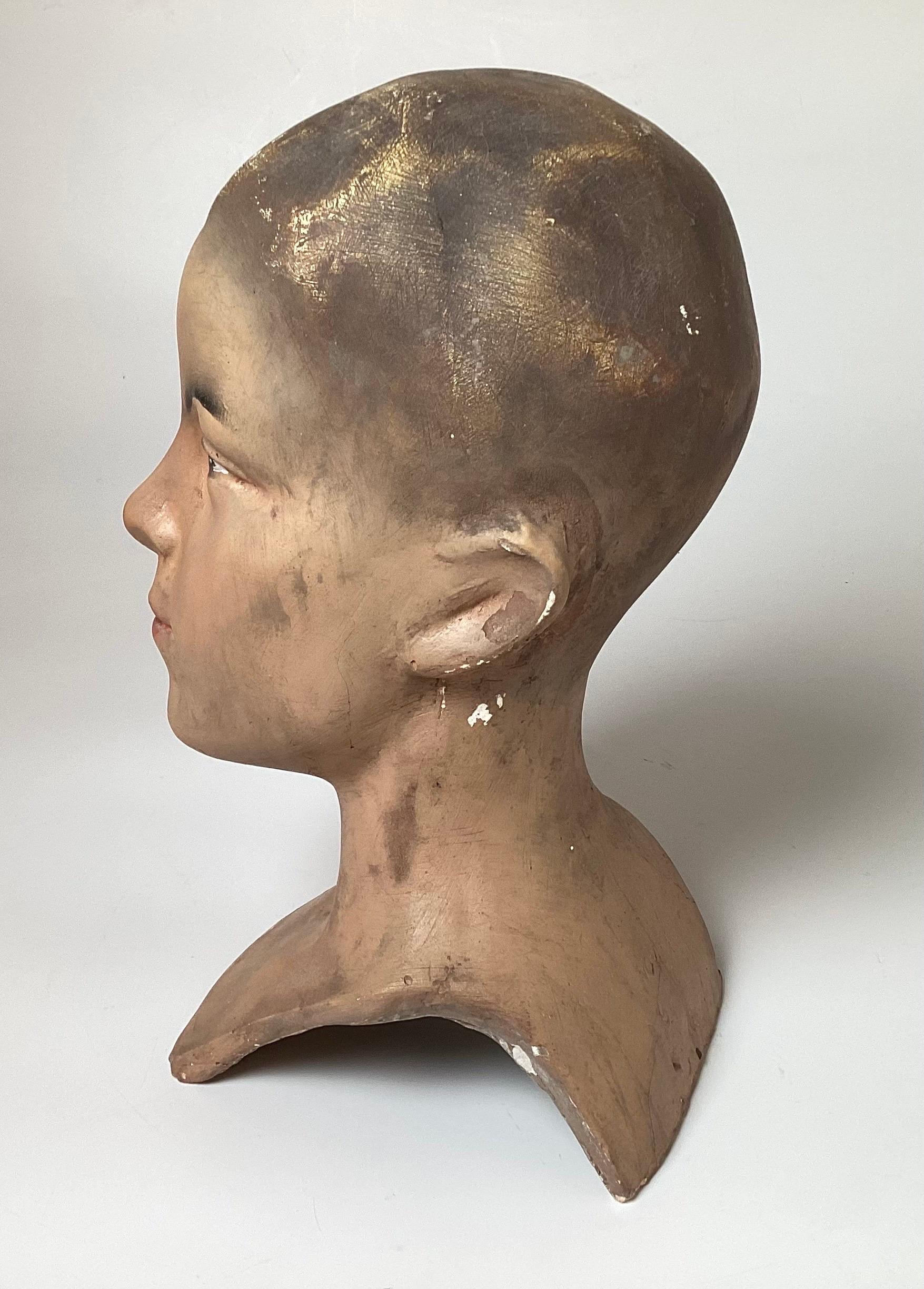 All original plaster mannequin hear from a Belgium department store. The face of a teen aged young man with the original hand panted face and hair, made of a heavy plaster. Europe, 1940s 12 inches tall.