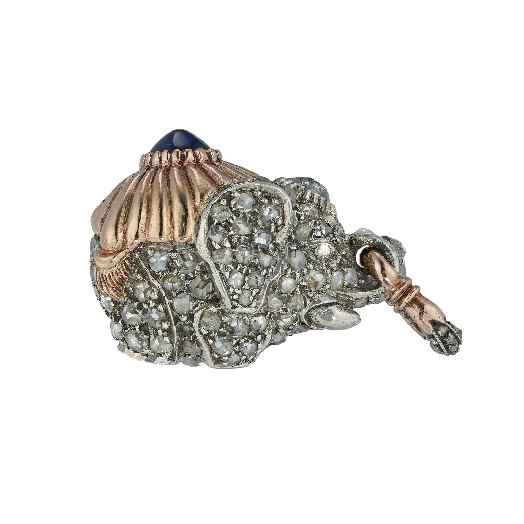 A Faberge diamond-set elephant pendant, with rose-cut and old-cut diamonds set throughout on silver, the back decorated with a rose gold saddle cloth with extending gold tassels the centre set with a cabochon-cut sapphire, suspended from a