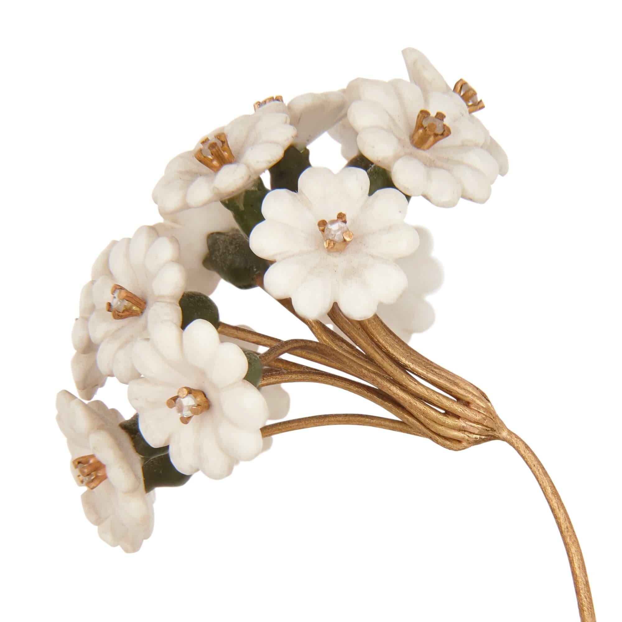 A Fabergé style rock crystal, gilt, diamond and nephrite flower model.
Continental, 20th century.
Measures: Height 18cm, width 7.5cm, depth 6cm.

In a rare design, exceptional for the small diamonds mounted in each of the flower heads, this