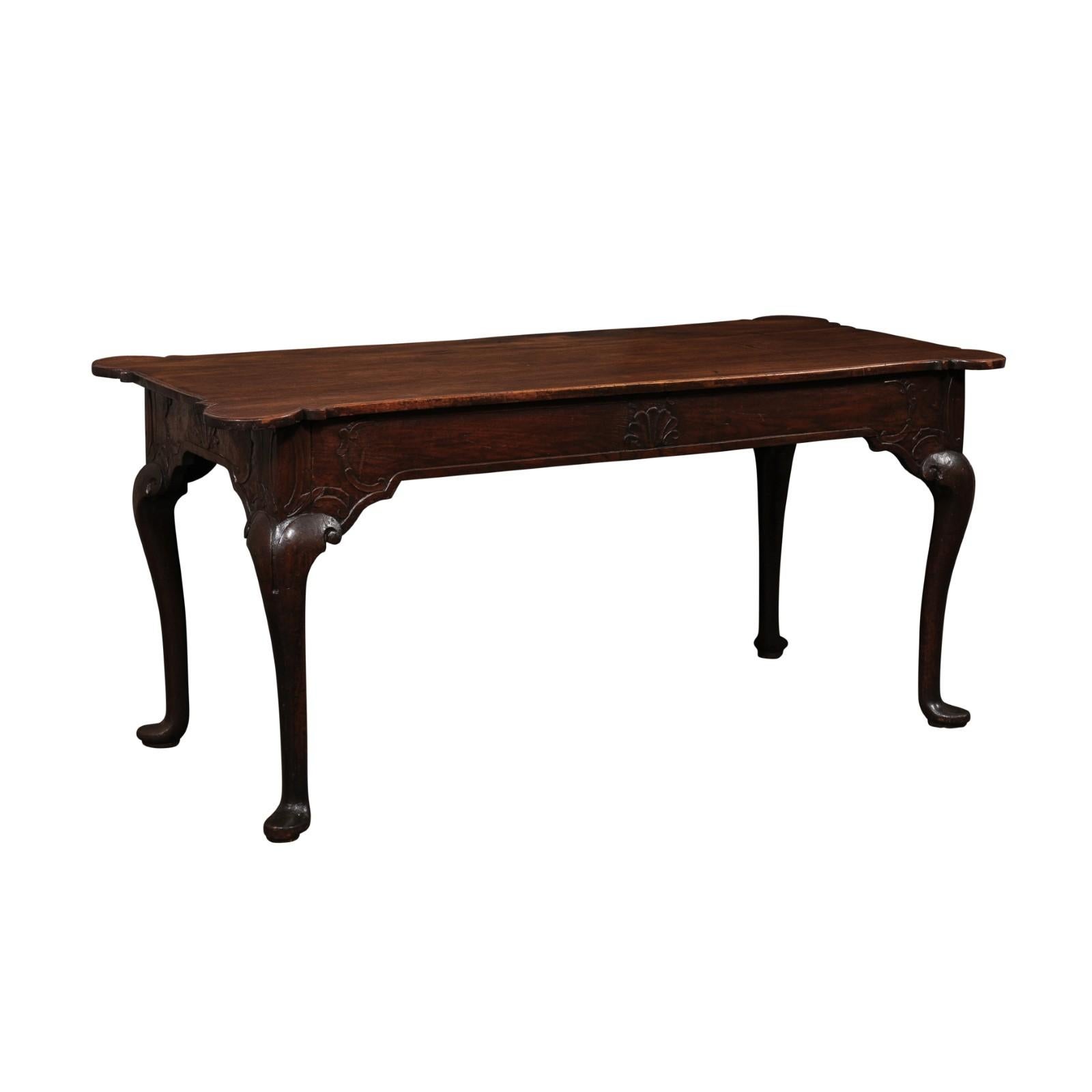 A handsome Portuguese carved-walnut console table, with carved apron and nicely profiled top corners, from the 18th century. This antique table from Portugal, approximately 6 feet in length, has a rectangular-shaped top with beautifully carved,