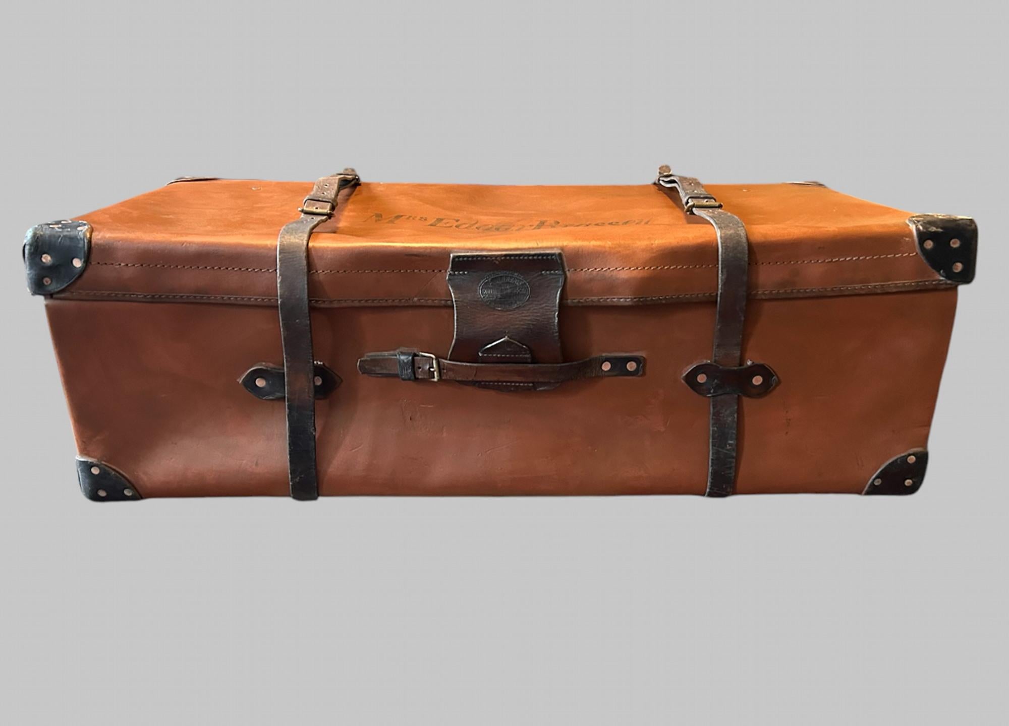 A lovely Leather Suitcase made by A W Dear of Knightsbridge, Hyde Park Corner c1930 of good size as either a trunk or suitcase. With brass and copper fittings and lock (no key) leather straps, carrying handles and leather cover for lock with wooden