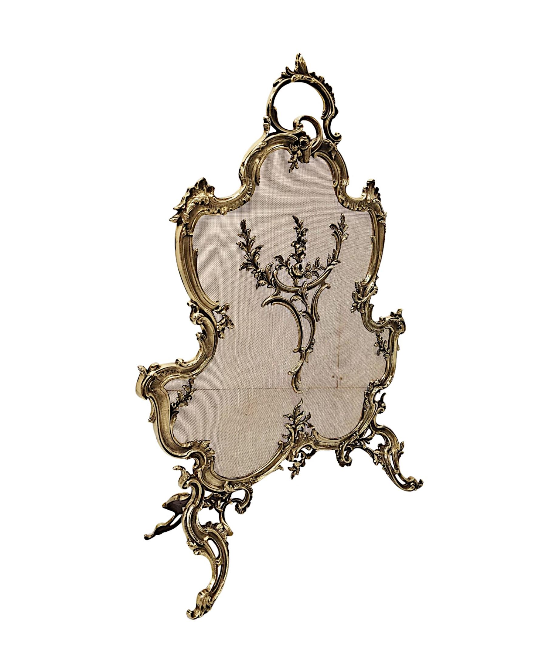 A fabulous 19th Century polished brass fire screen in the Rococo manner, fully restored and of exceptional quality.  The shaped and curved protective wire mesh is set within an intricately detailed cast brass frame with beautiful motifs comprising