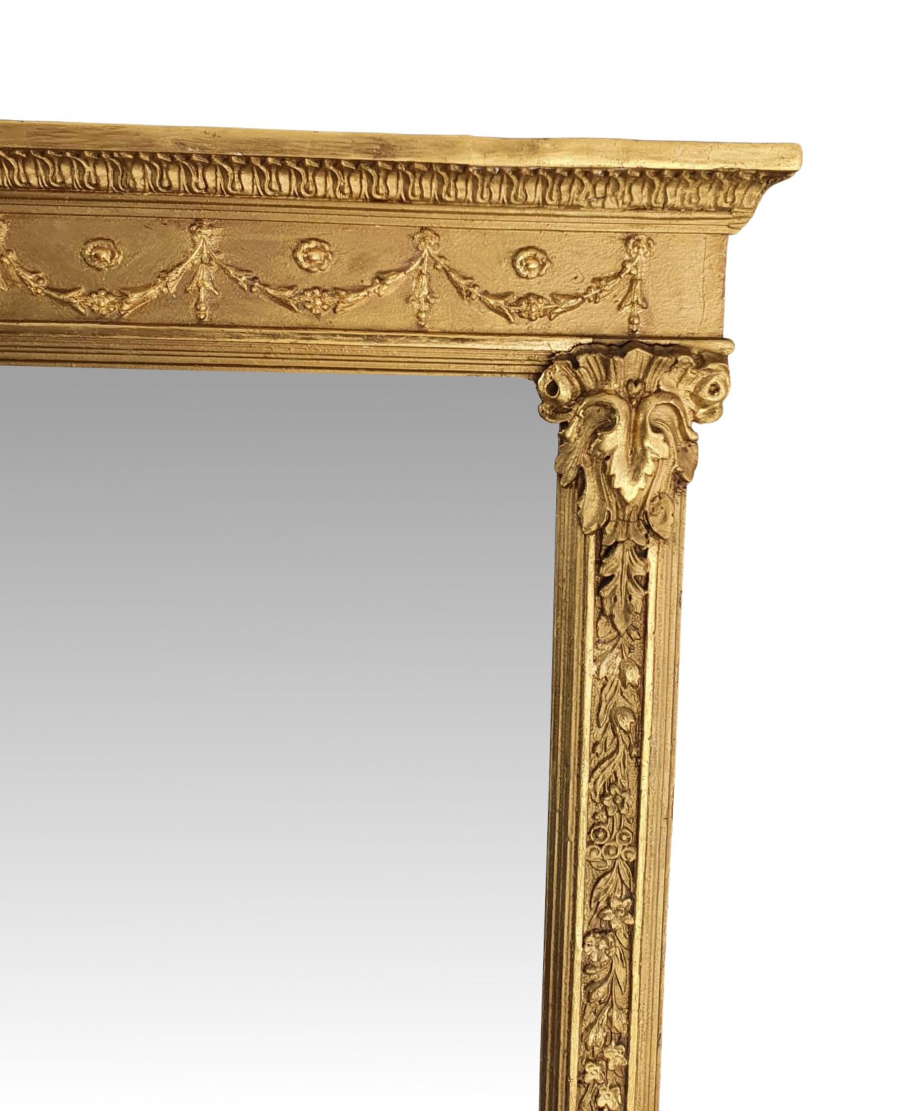 A fabulous 19th Century giltwood overmantle mirror in the manner of Adams. The mirror glass plate of rectangular form set within a beautifully hand carved and moulded giltwood frame. Surmounted with overhanging stepped pediment raised above frieze