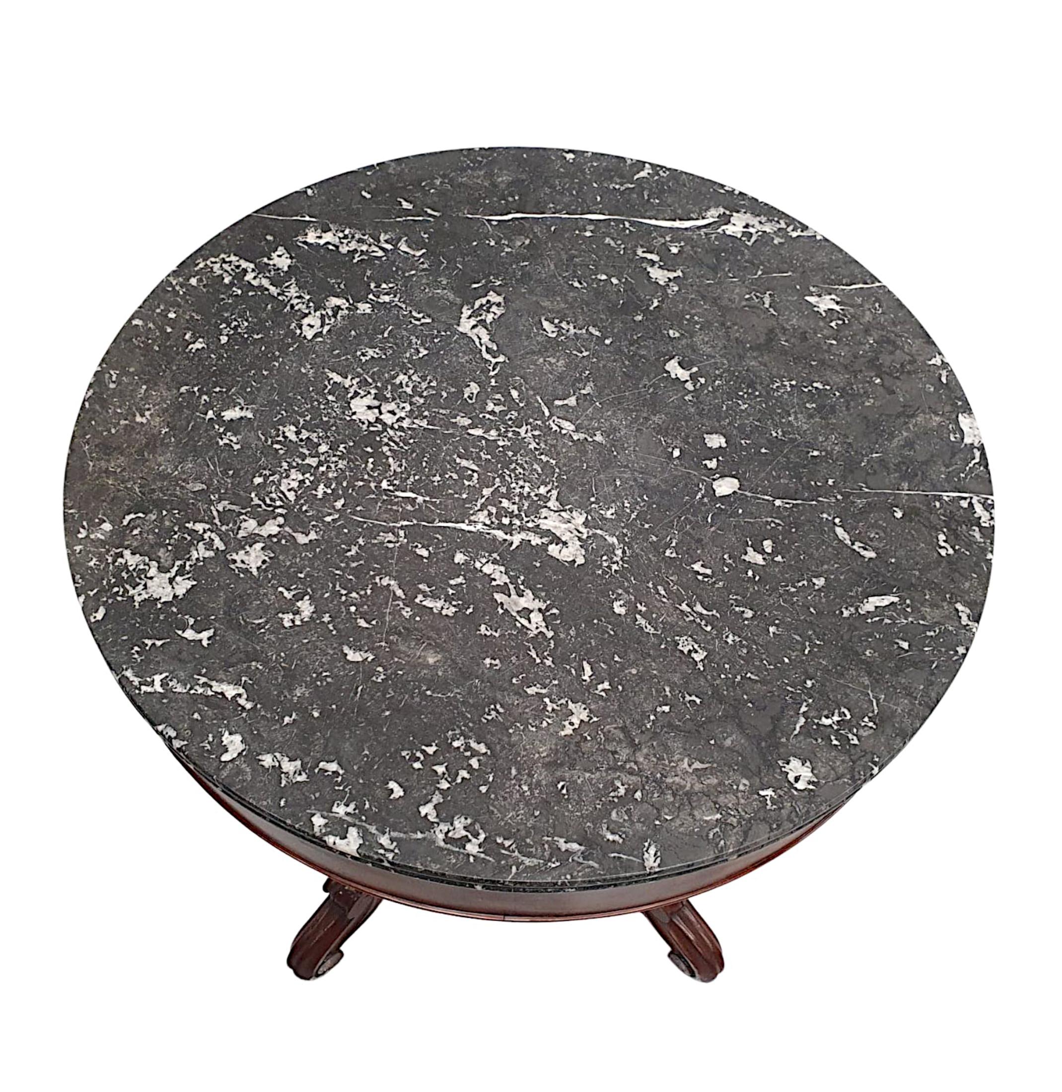 A fabulous 19th Century mahogany marble top centre table, of neat proportions, fantastic quality and finely hand carved with beautifully rich patination and grain.  The stunning moulded, double edged Marquina Black marble top of circular from is