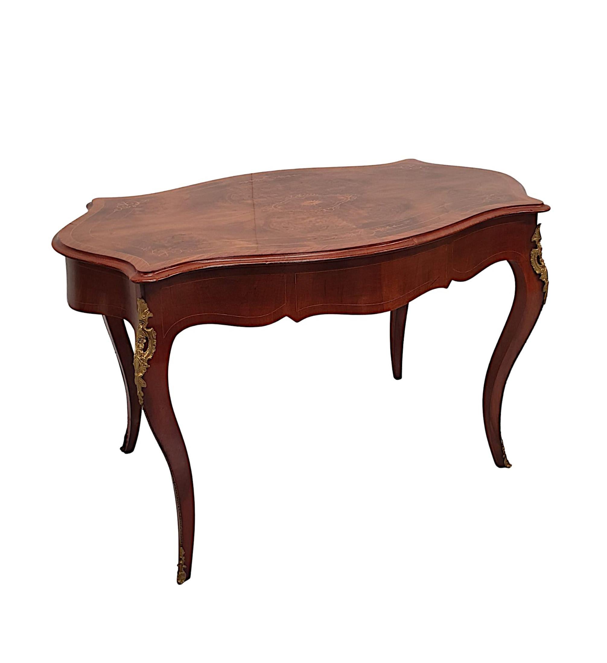 A fabulous 19th century burr walnut side table or desk of gorgeous quality, finely hand carved, ormolu mounted and line inlaid throughout with beautifully rich patination and fine grain. The moulded, crossbanded and line inlaid top of serpentine