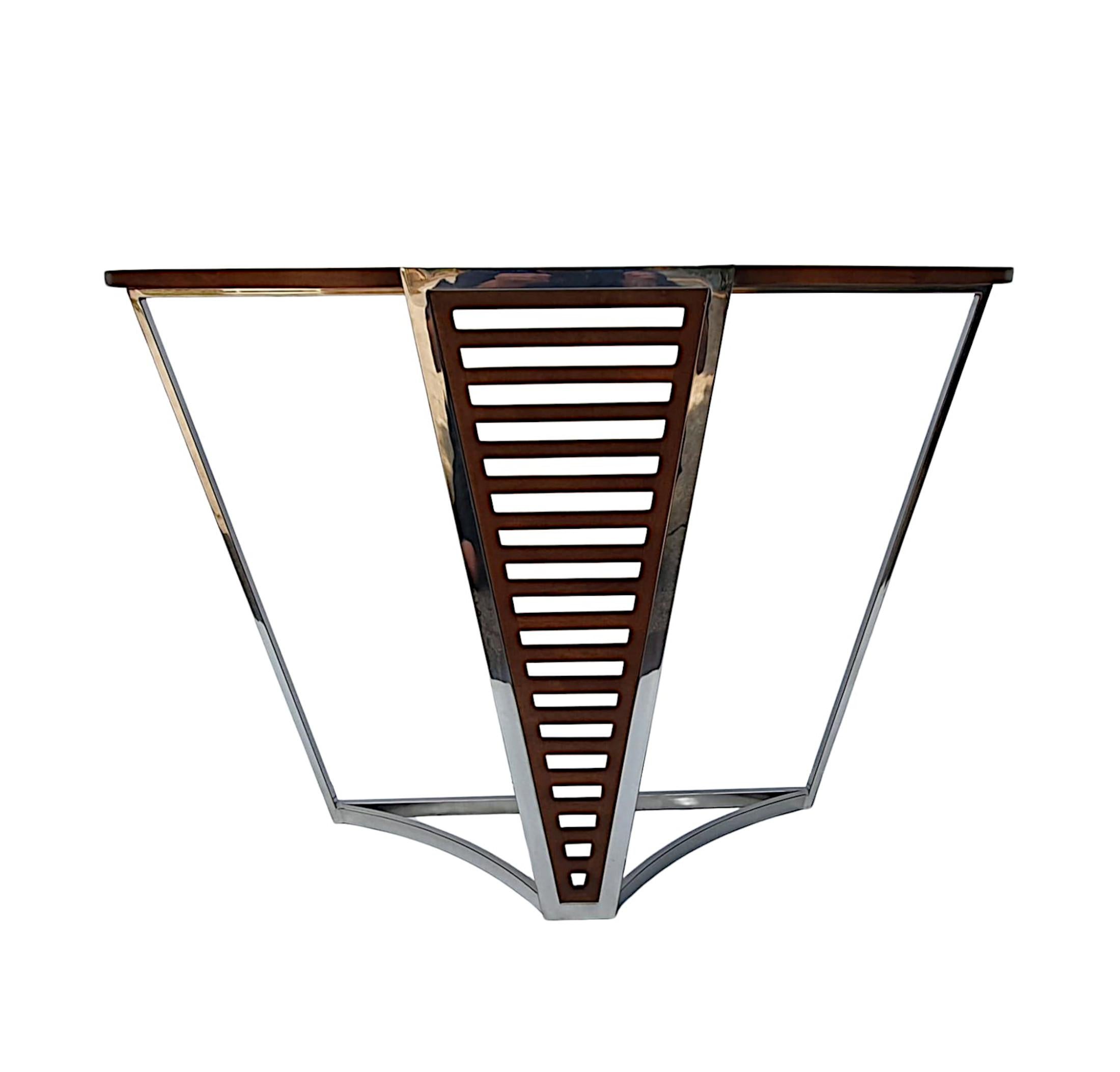 A fabulous hand made Art Deco style richly patinated cherrywood console table of exceptional quality, neat proportions and finely carved with a stunningly clean simple design and framed throughout with gorgeous chrome border detail.  The well