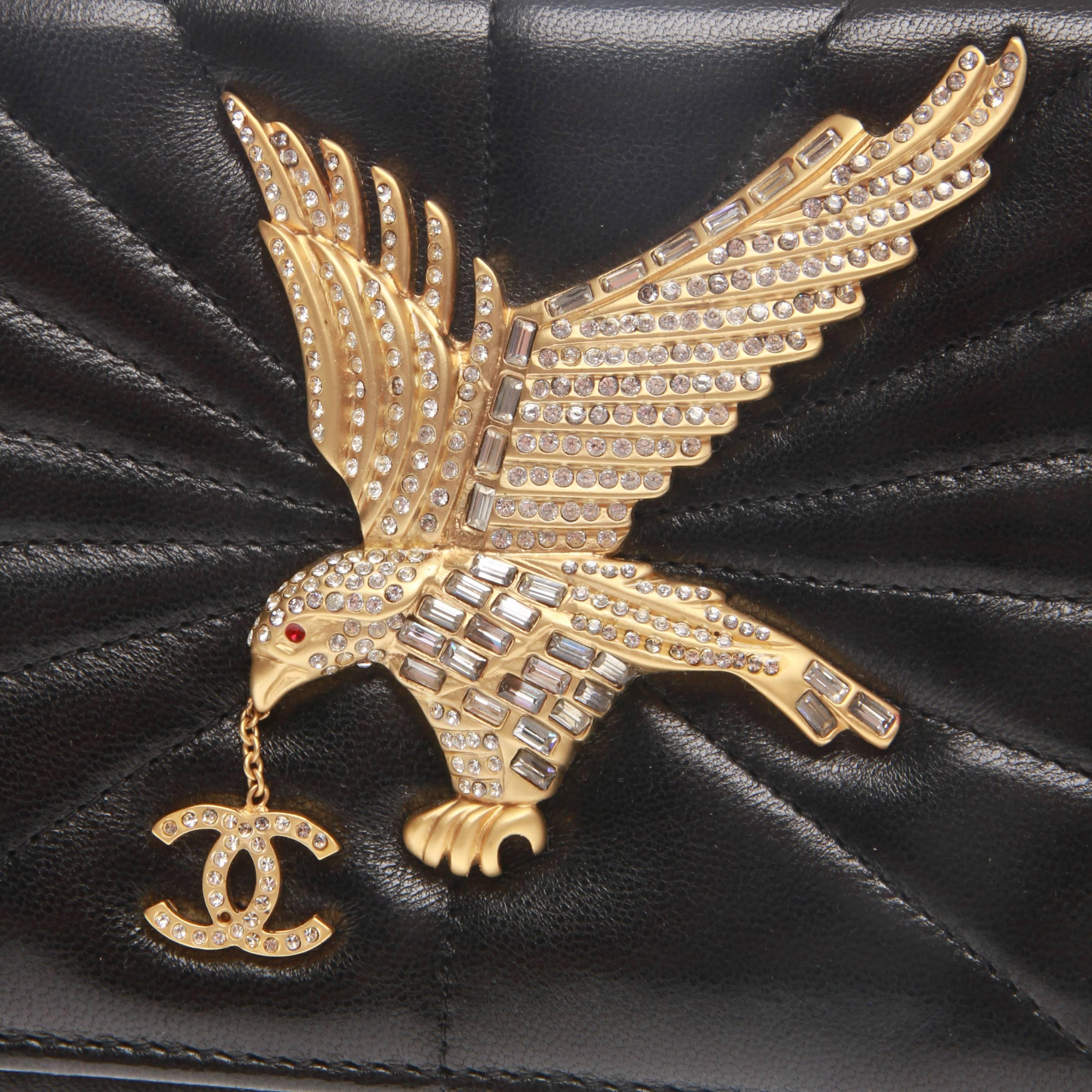 Chanel Vintage Gold Crystal Eagle Dangle CC Brooch Leather Cocktail Clutch

A fabulous black Chanel quilted leather clutch with gold-tone hardware, eagle and CC embellishment crystals by CHANEL.
It features interior zipped wall pocket, interior slip