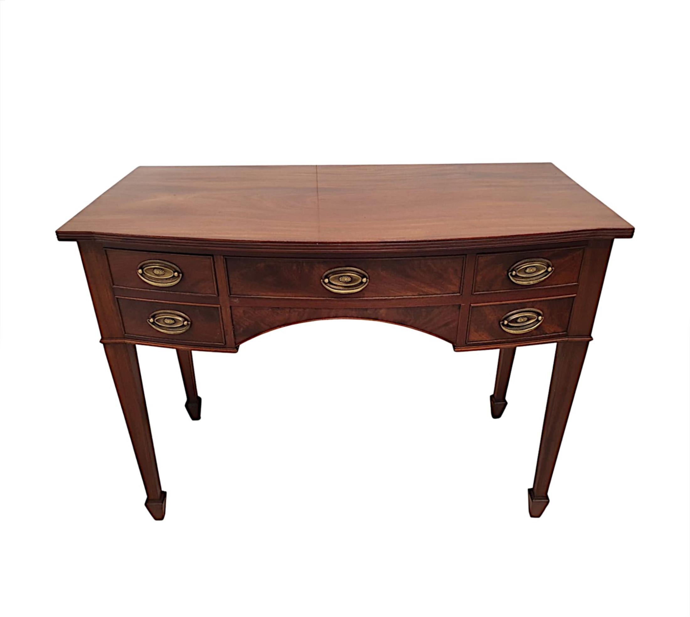 A fabulous Edwardian bowfront mahogany console or hall table, of exceptional quality and finely carved with gorgeously rich patination and grain. The shaped and moulded top with a beautiful reeded edge is raised above shaped frieze fitted with
