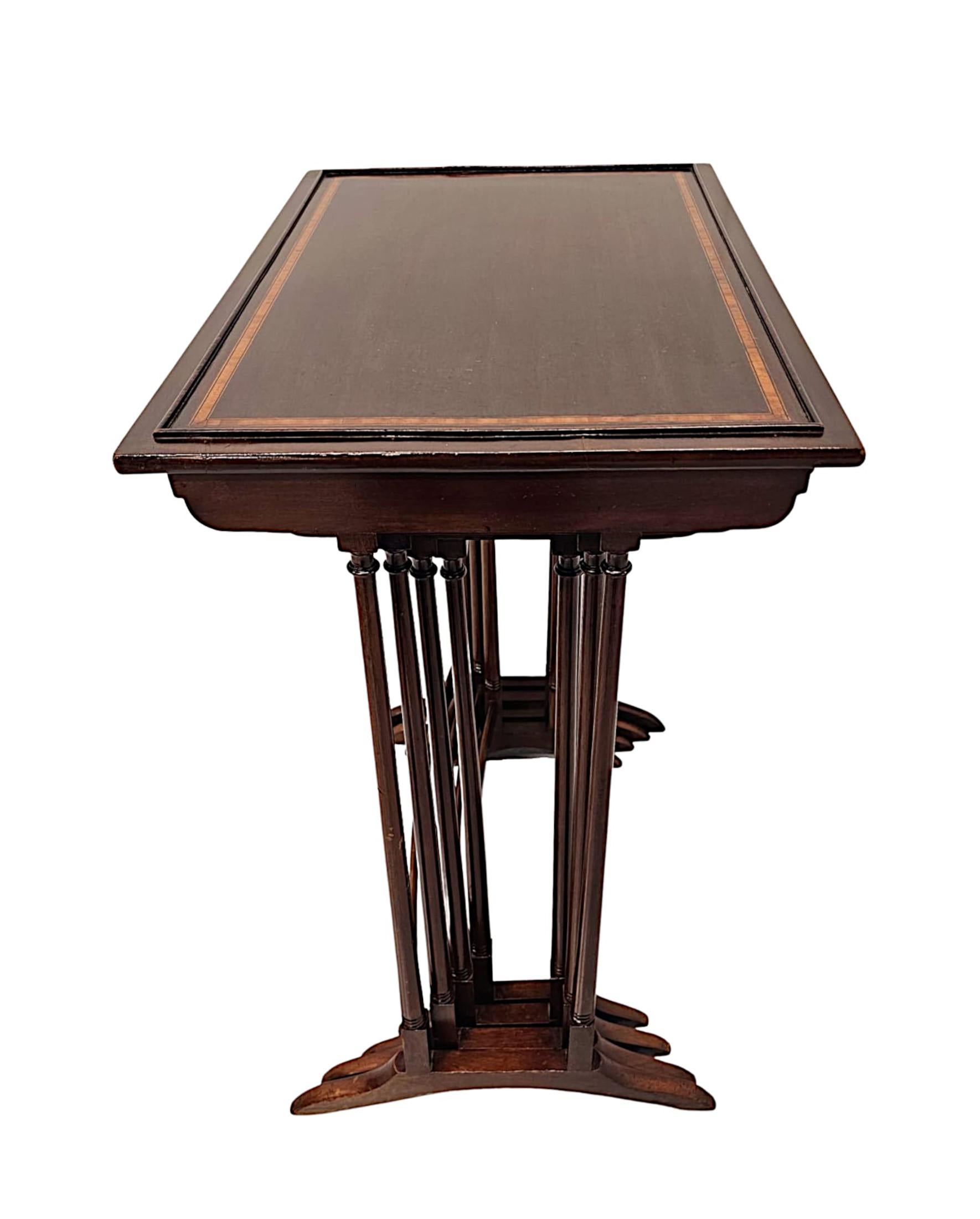 A fabulous Edwardian nest of four richly patinated mahogany tables, of exceptional quality, finely carved and beautifully inlaid throughout.  The well figured, moulded, galleried and inlaid top of rectangular form is supported on a pair of elegant