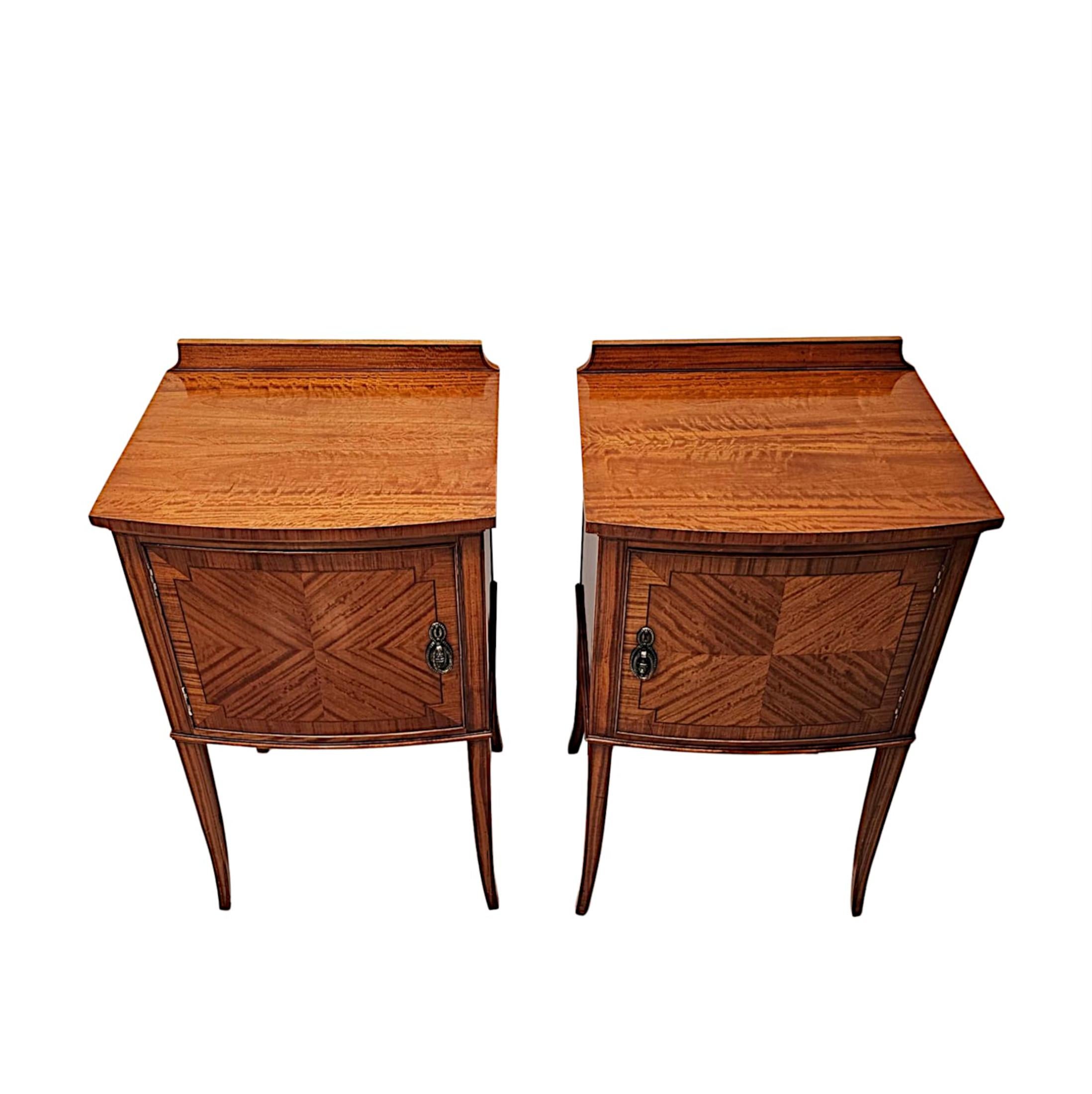 A fabulous pair of Edwardian satinwood bedside cabinets, finely carved with gorgeously rich patination, grain and with beautifully detailed crossbanding, quarter veneer and inlay throughout.  The well figured, moulded, bowfront top of rectangular