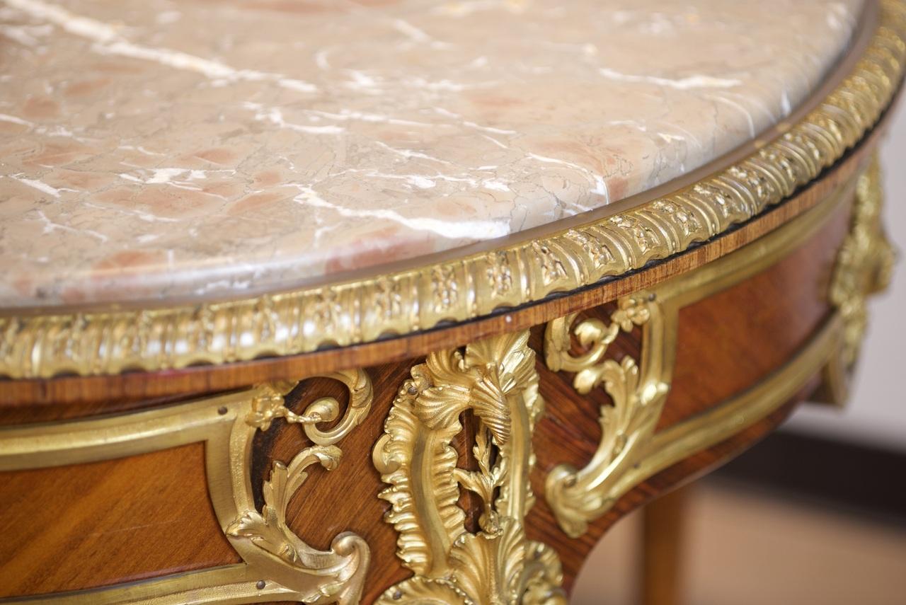 A French ormolu-mounted kingwood Guéridon by Zwiener, Paris, circa 1890

The associated circular brèchemarble top above a frieze mounted with masks of Apollo, with one drawer and raised on cabriole legs, the mounts variously incised 'ZJ', the lock