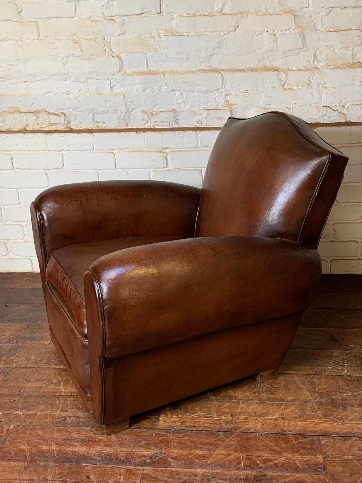 A Fabulous French Leather Club Chair, Chapeau de Gendarme Model, Circa 1940’s

This handsome and inviting chair is an absolute classic. With its overstuffed Cuban cigar arms, generous seat, and proportions it’s a great single chair. It has a deep