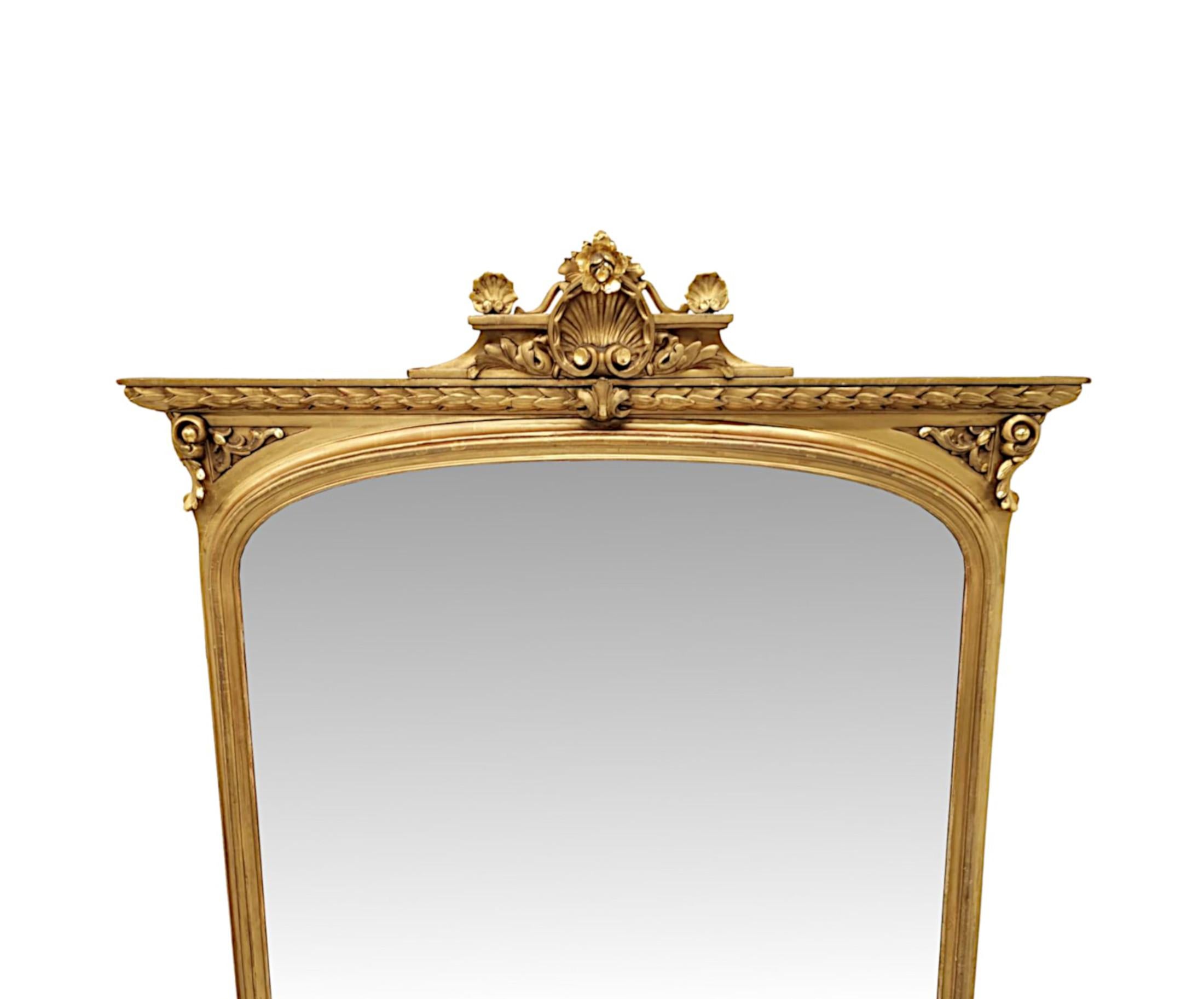 A fabulous 19th Century giltwood overmantel mirror of large proportions, finely hand carved and of exceptional quality.  The arch top mirror glass plate is set within a beautifully simple, moulded and fluted giltwood frame of rectangular form. 