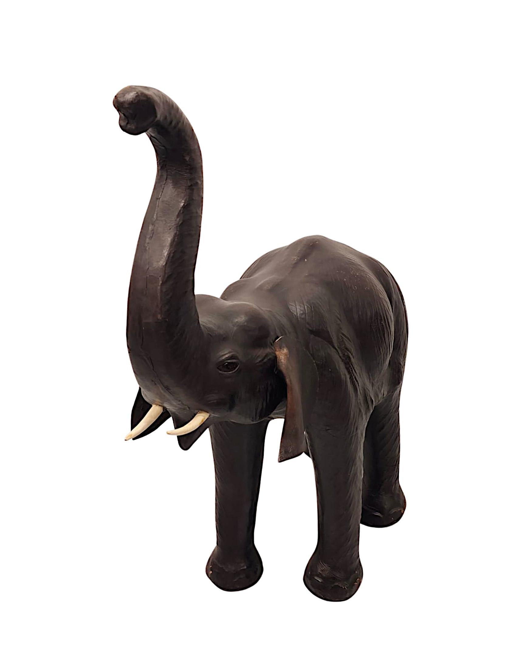 A fabulous 20th Century animalier leather sculpture of grand proportions and exceptional quality, depicting an elephant striding with trunk raised, superbly modelled, finely detailed and with gorgeously rich patination to the leather.