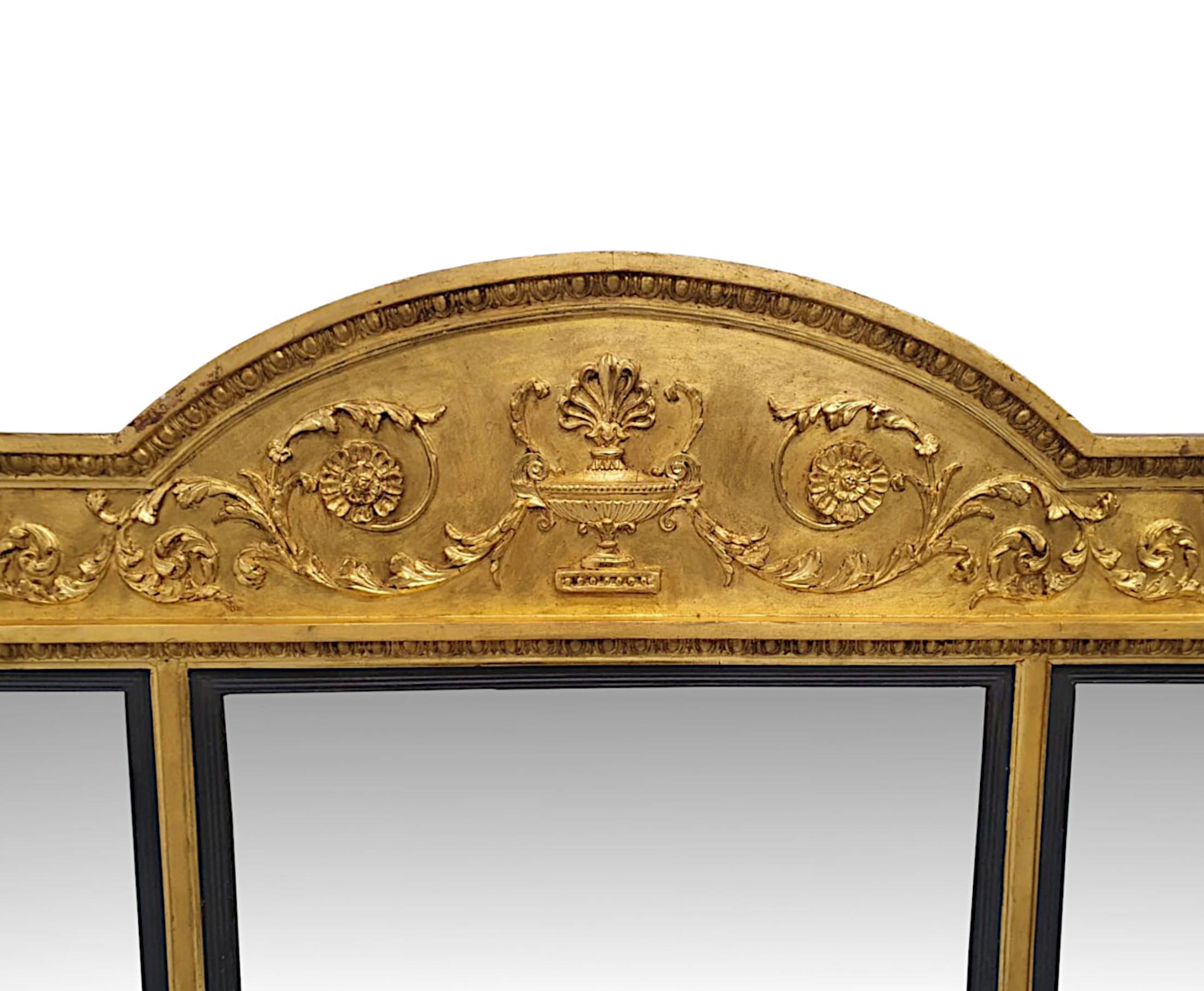A fabulous late 19th Century giltwood overmantle compartmental mirror in the manner of Adams.  The finely hand carved, moulded and fluted giltwood frame with applied flowerhead paterae, egg and dart detail throughout is surmounted curved