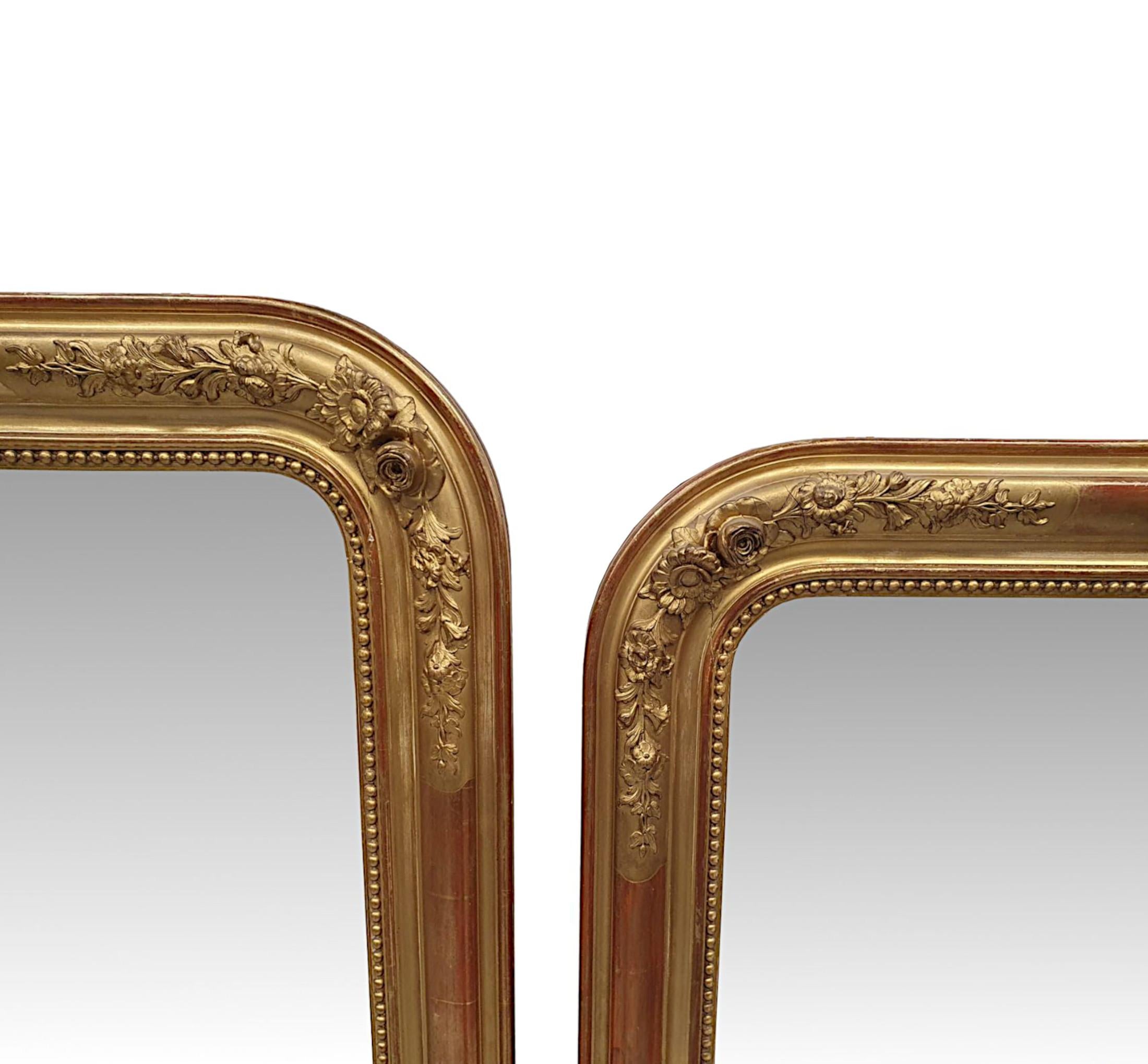 A fabulous near pair of 19th Century giltwood overmantle Mirrors with slight variation in size. The mirror glass plates of shaped rectangular form is set within a finely hand carved, moulded and fluted giltwood frames with an elegant beaded border