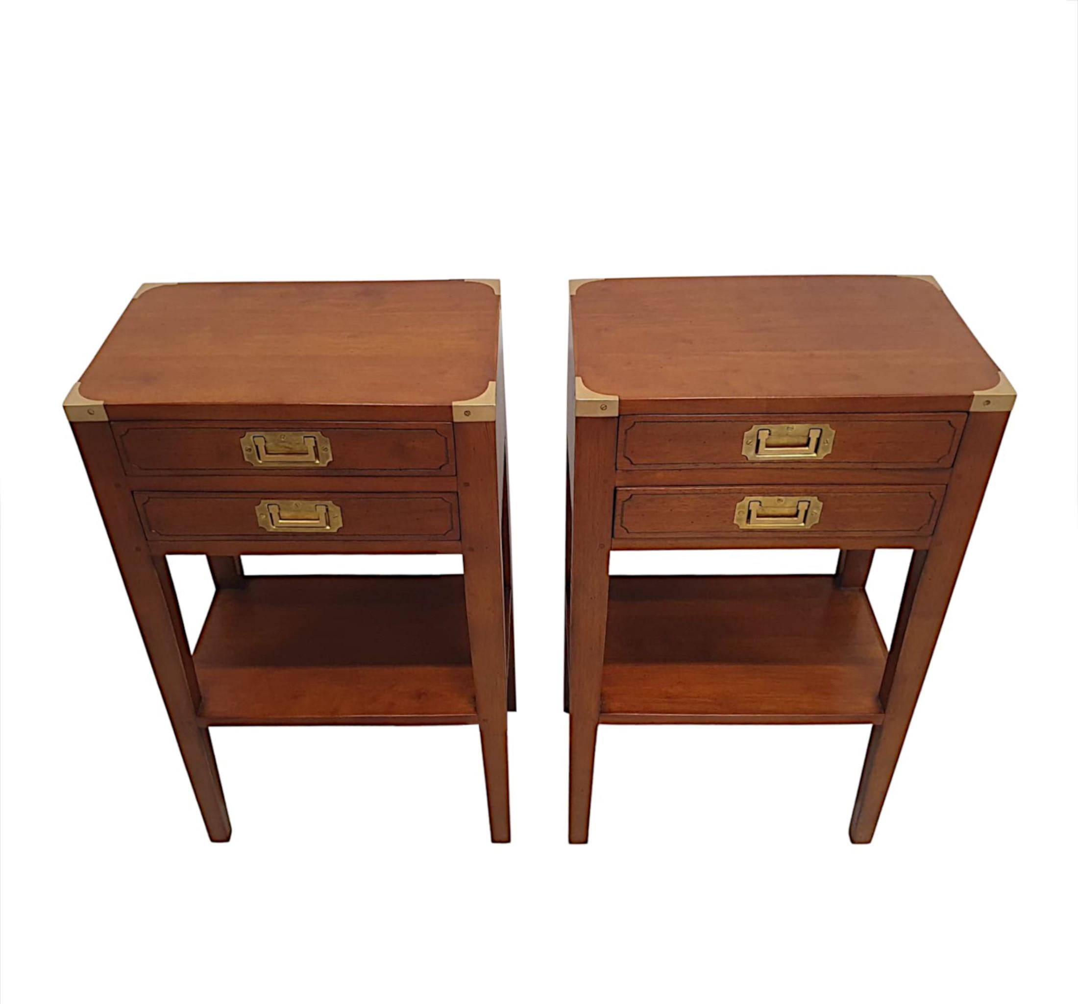 A fabulous pair of cherrywood, brass mounted campaign style side tables, of exceptional quality and with superb patination to the wood.  The moulded top of rectangular form fitted with brass corner mounts is raised over two panelled drawers with