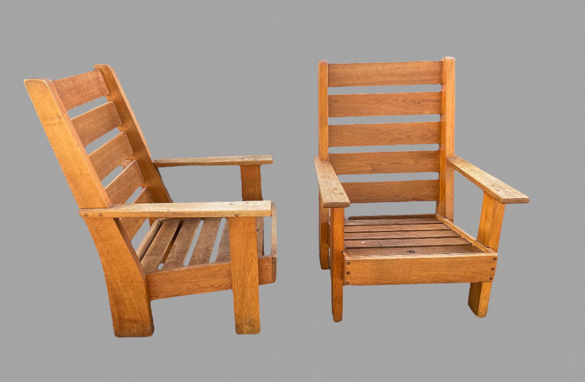 A Fabulous Pair of Unusual French Oak armchairs of good weight, Size and in very solid condition in arts and crafts style, both come with burnt stamp saying 'Atelier' with a name that cannot be made out. Measures: Seat depth 59 cm and seat height 40