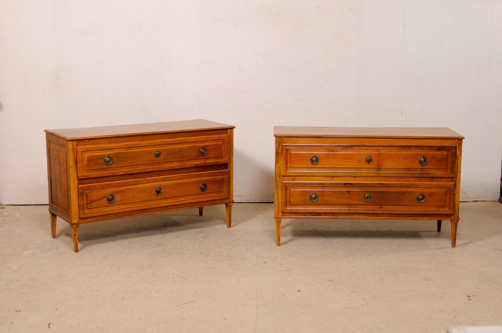 An Italian pair of nicely sized fruitwood chests from the turn of the 18th and 19th century. This pair of antique cassettiere (Italian for chests of drawers) from Italy each features a rectangular-shaped top, over a decoratively raised paneled case,