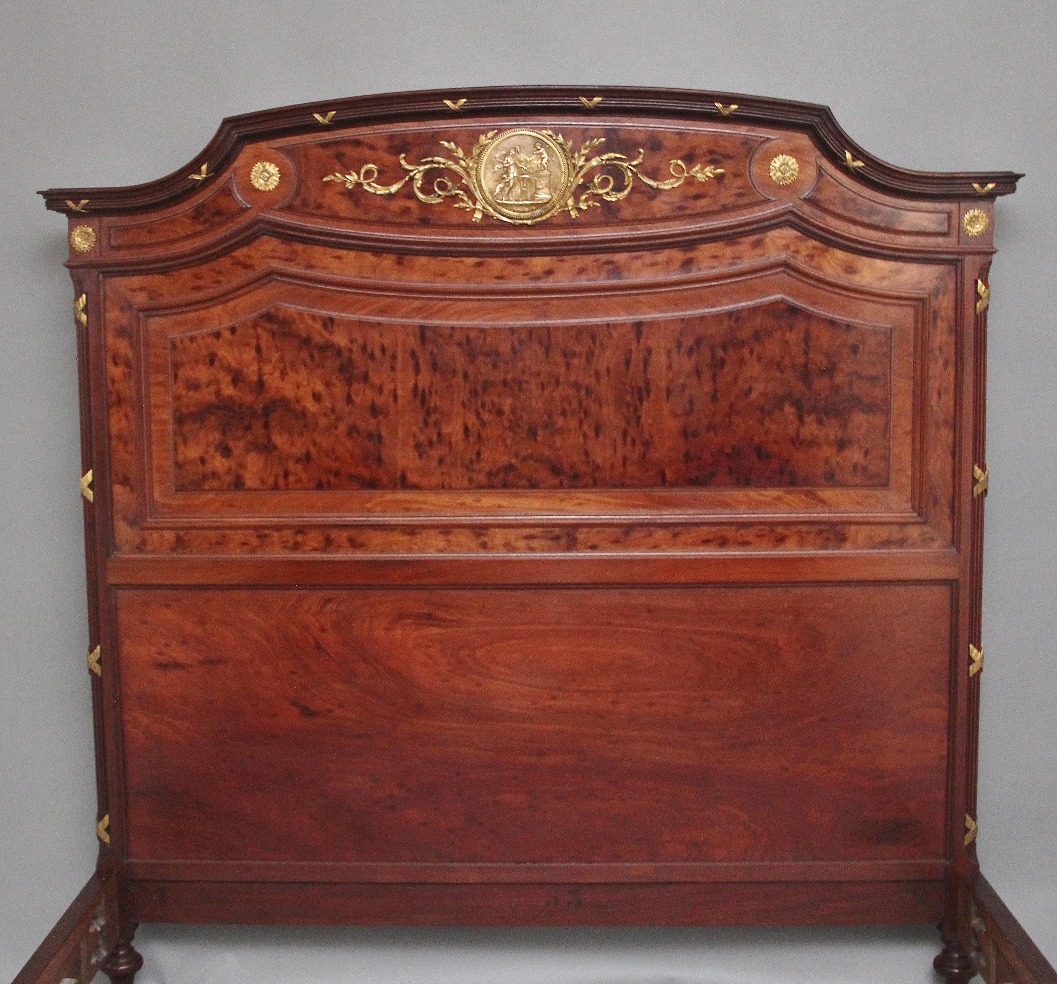 A fabulous quality 19th Century French plum pudding mahogany and brass bed in the Neoclassical style, the tall headboard having a shaped and reeded top with ormolu decoration, the sides in the same manor as the top but with canted corners,the large