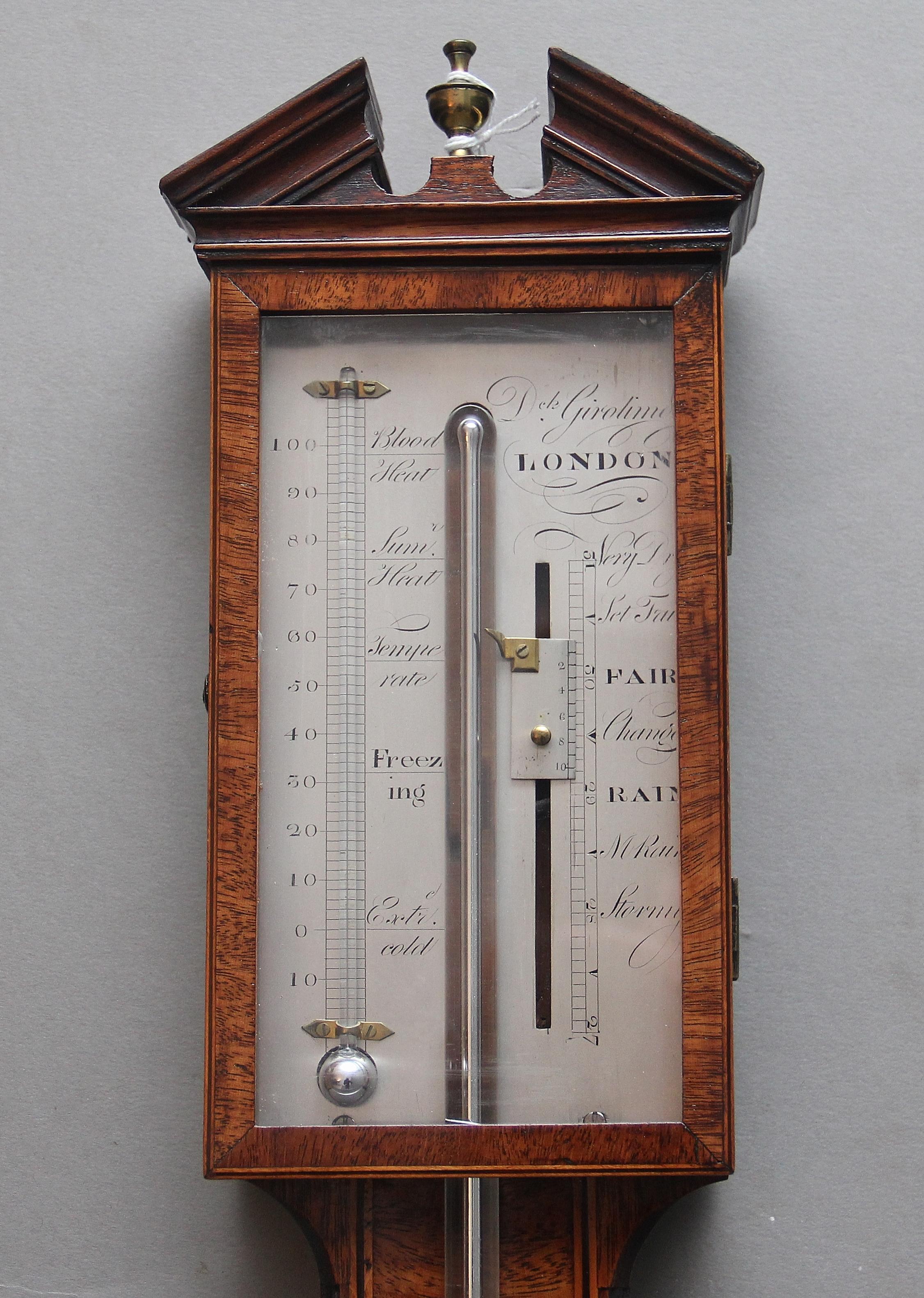 A fabulous quality early 19th century mahogany stick barometer by Girolimo of London, having an architectural top with a central brass finial, rectangular silvered dial with a glazed and hinged door, the dial itself displays weather notations and
