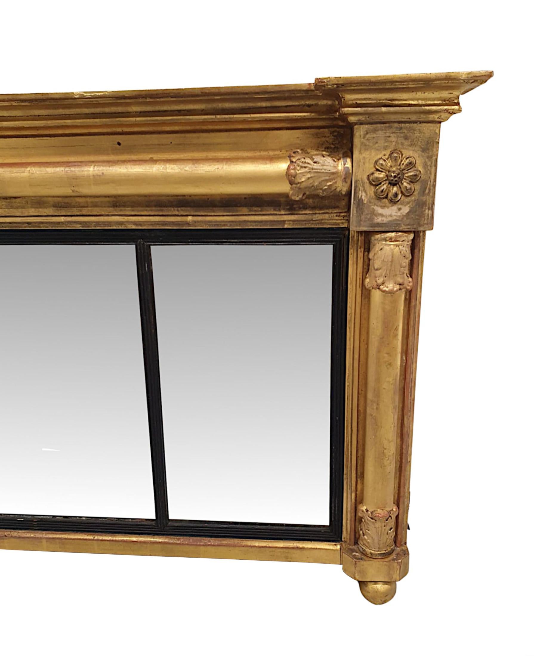 A fabulous and unusual early 19th Century William IV giltwood compartmental mirror, finely hand carved, of lovely quality and low and wide proportions.  The moulded and fluted giltwood frame is surmounted with an overhanging inverse breakfront