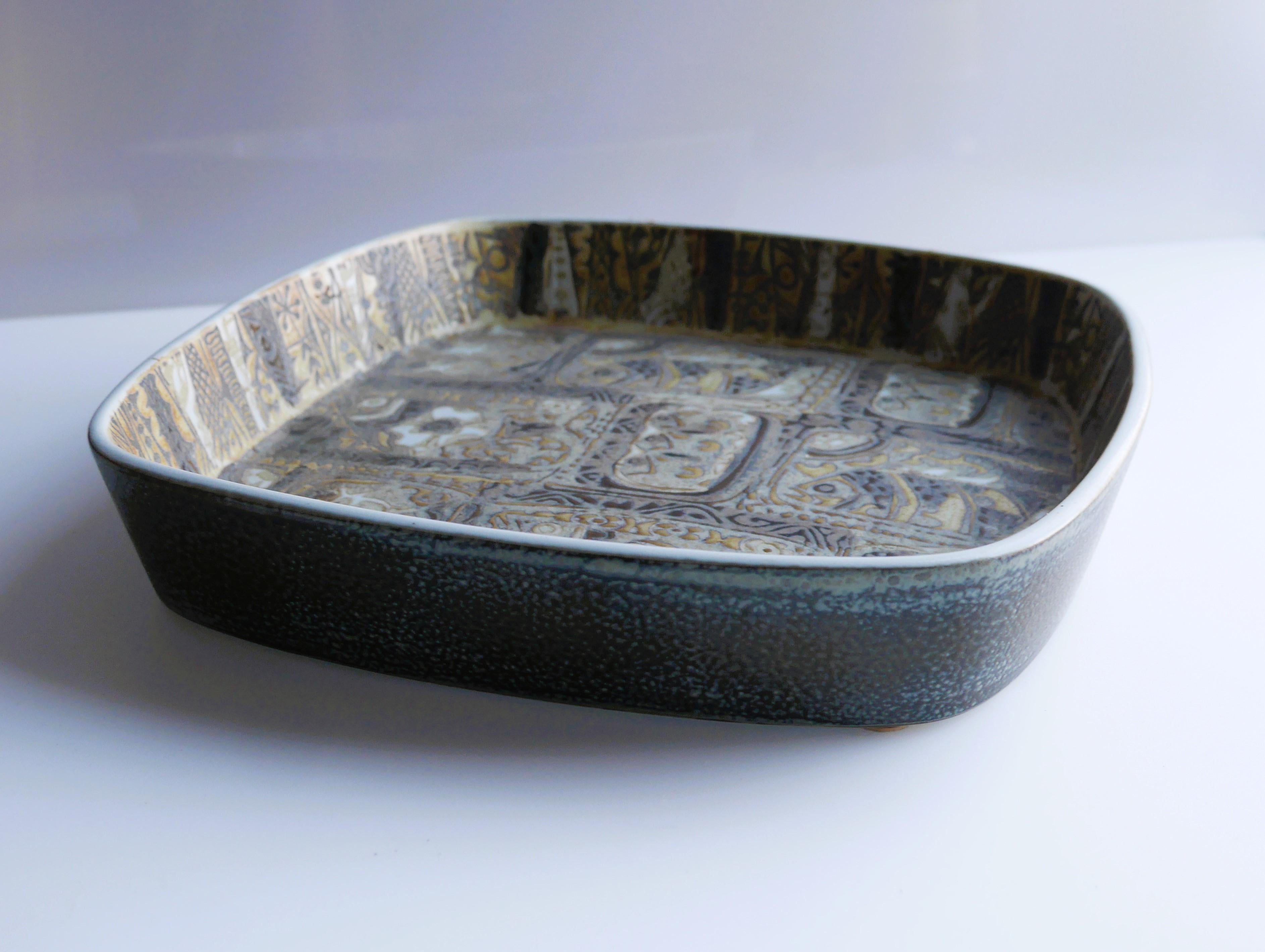 A fantastic faience bowl or plate by Nils Thorssen from Royal Copenhagen. The bowl has an abstract and intricate pattern, which reminds you of a mosaic church window, it is intricate, detailed and shows amazing professional skills. The model is