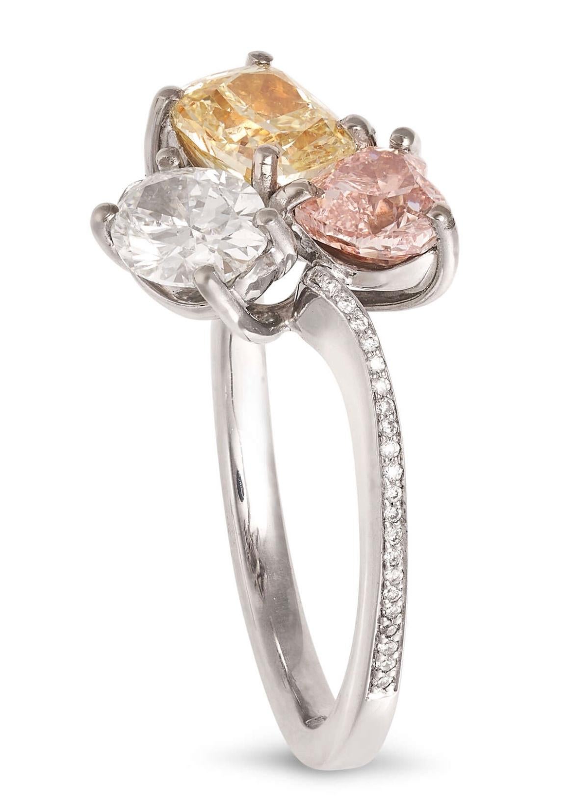 Description
A FANCY COLOURED DIAMOND DRESS RING BY SCARSELLI in 18ct white gold, set with a pink heart cut diamond of 0.63 carats, an oval cut diamond of 0.60 carats and a cushion cut yellow diamond of 0.90 carats, the band accented by round cut