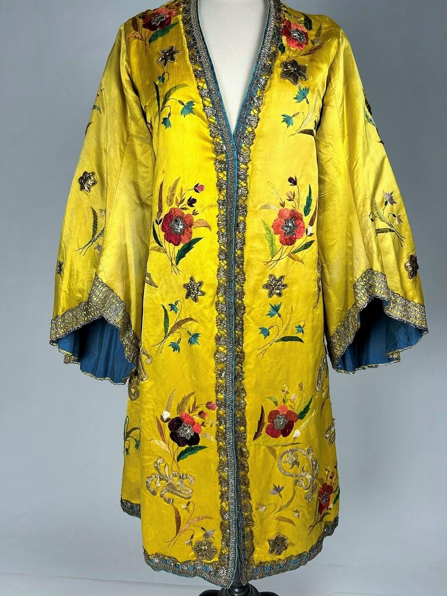 Circa 1860-1900
France

Spectacular Fancy or theatre kaftan in gold-yellow satin embroidered with silk and applied with gilded blade embroidery dating from the late 19th century. Orientalist style conical cut and wide pagoda sleeves. Around the