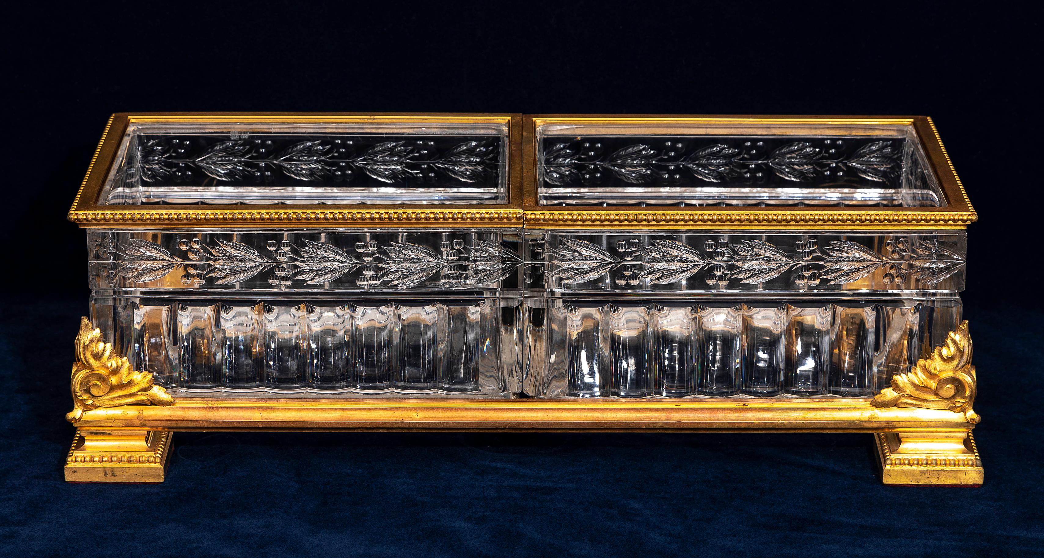 A Fantastic, Rare, and Large 19th Century French Baccarat Ormolu and Crystal Centerpiece. The piece consists of two thick and dense crystal compartments, each framed with an ormolu border featuring a beaded edge. The crystal is highly transparent