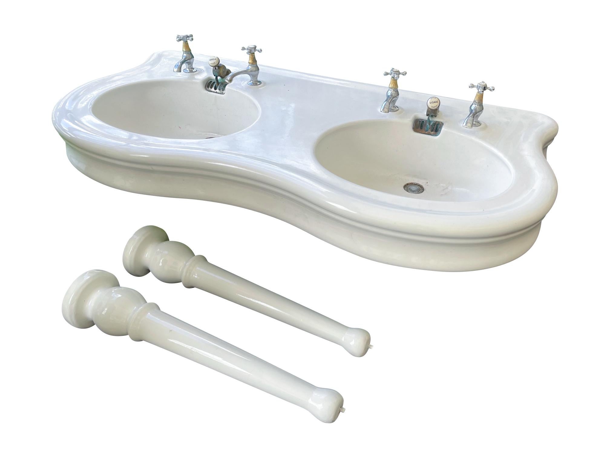 A fantastic double sink with column legs, in super condition for its age, circa 1910. Complete with original wastes, but with replacement taps, the taps are untested and could be ideally replaced with period examples, the wastes are untested and