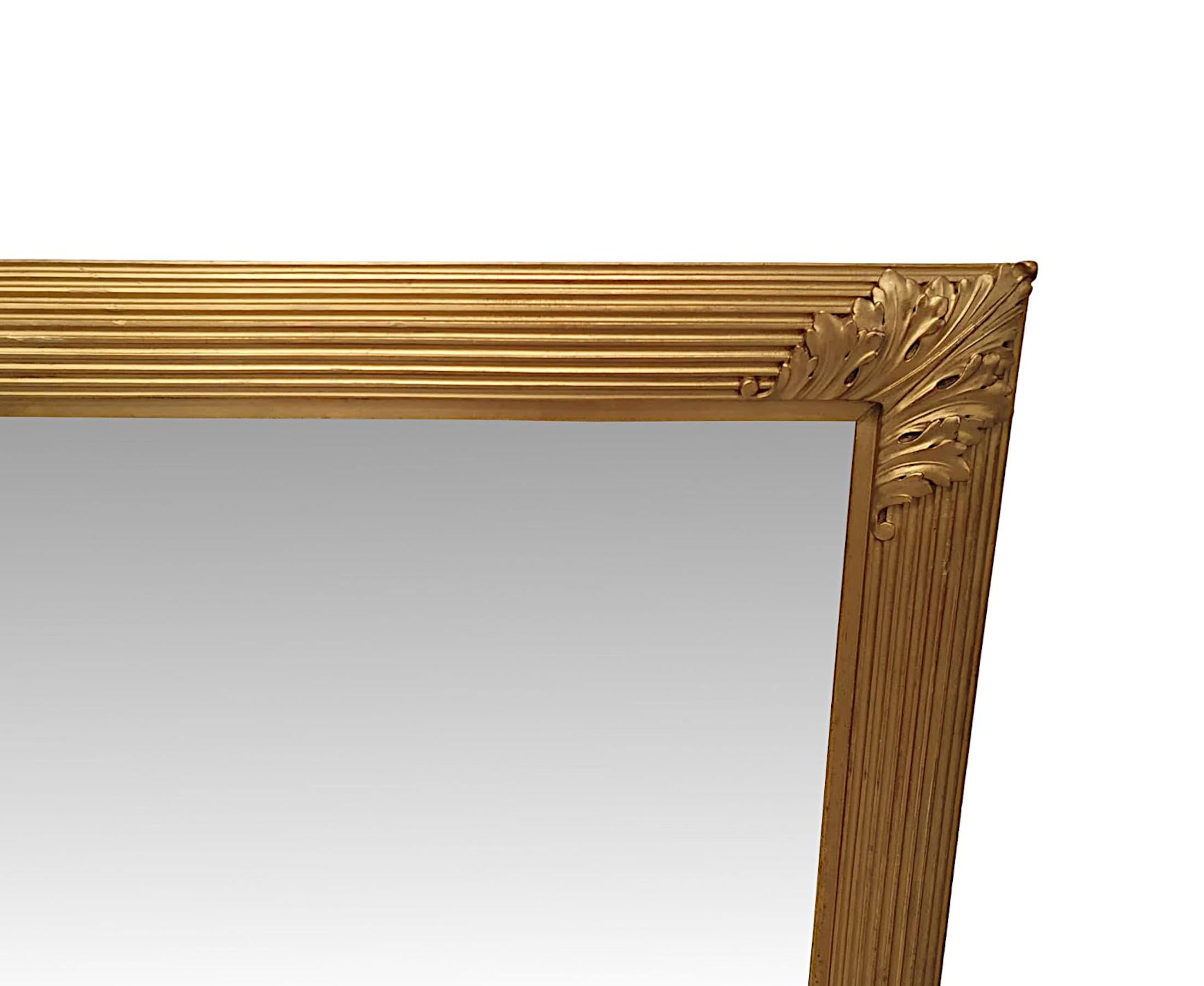 Un fantastique miroir d'entrée ou de cheminée en bois doré du 19ème siècle de grandes proportions. La plaque de miroir de forme rectangulaire se trouve dans un élégant cadre simple en bois doré moulé, sculpté à la main, avec des détails en creux et