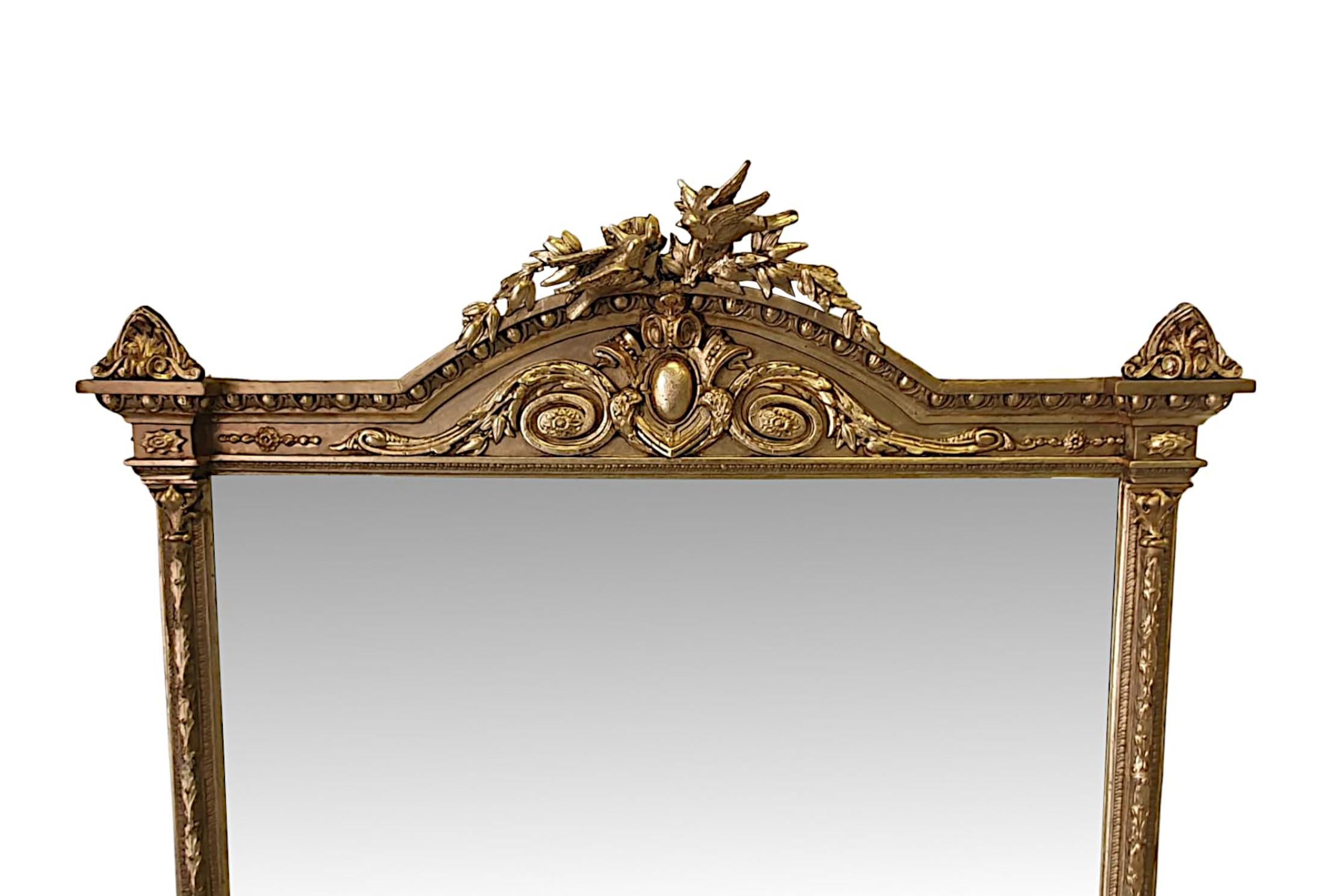 A fantastic 19th century giltwood mirror of large proportions. The mirror glass plate of rectangular form set within a stunningly hand carved, moulded giltwood frame flanked with borders of beading and foliate. The frieze with stylised centred