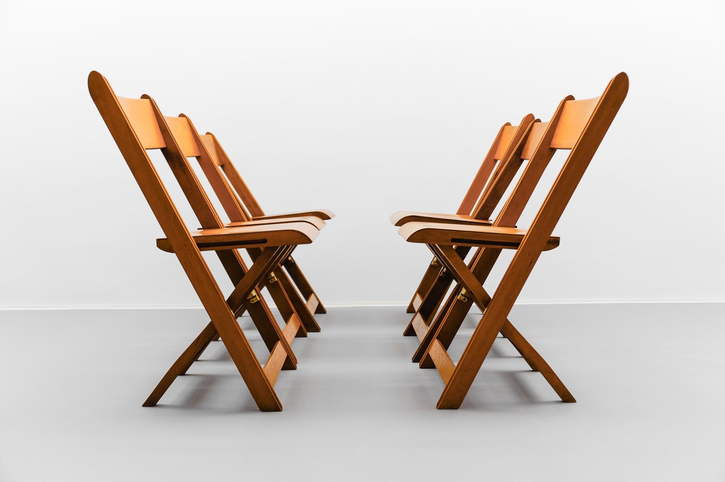 A Fantastic Set of 6 German Cinema Wooden Folding Chairs from the 40s / 50s

There are 14 pieces in total. They are offered here at 1stDibs as two sets of 4 and one set of 6 in separate auctions.

The chairs are clean and ready to use.

Great patina